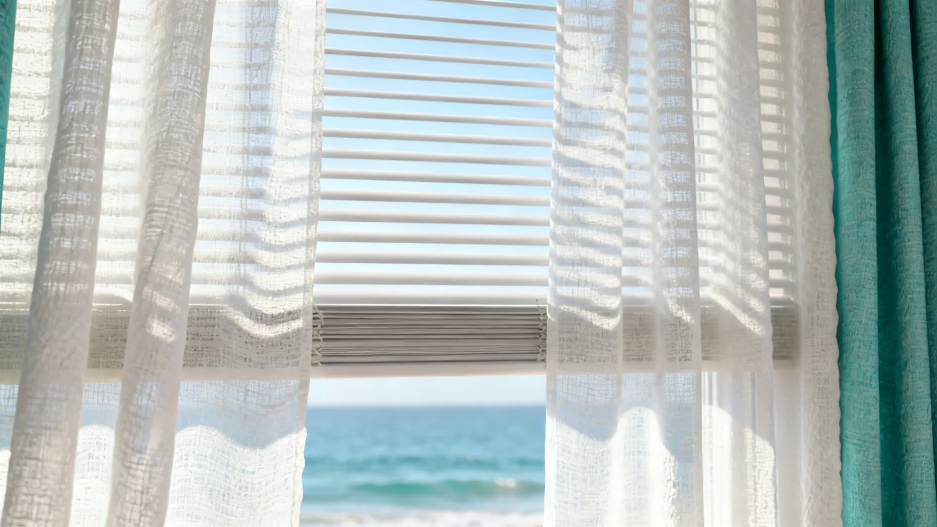 Layered sheer curtains with adjustable blinds in a sunlit coastal living room