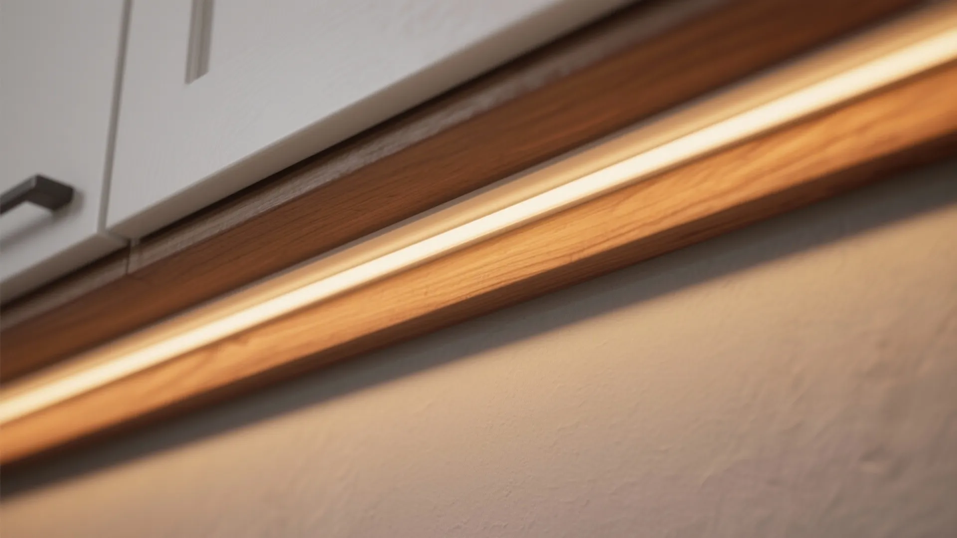 Macro of an LED diffuser under a white oak cabinet with warm glow on the grain.