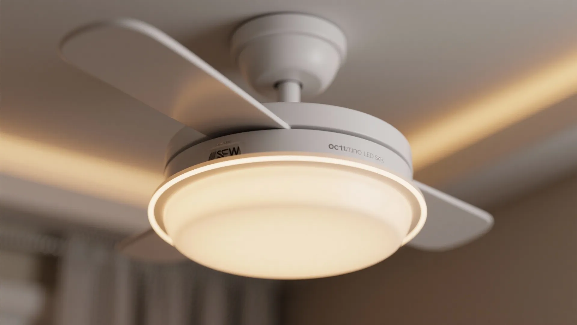 Close up of white ceiling light fan with glowing led light and white fan blades