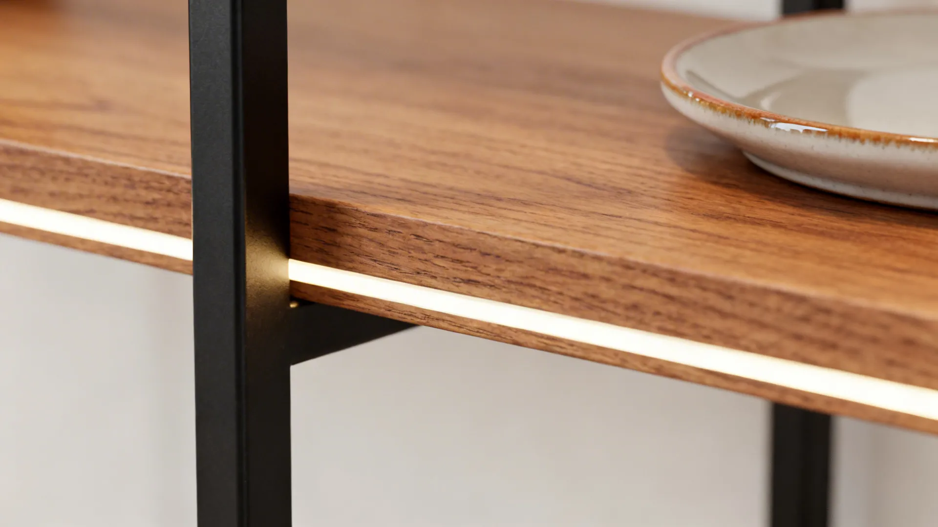 Close up view of wooden shelf with built in led light strip and white plate