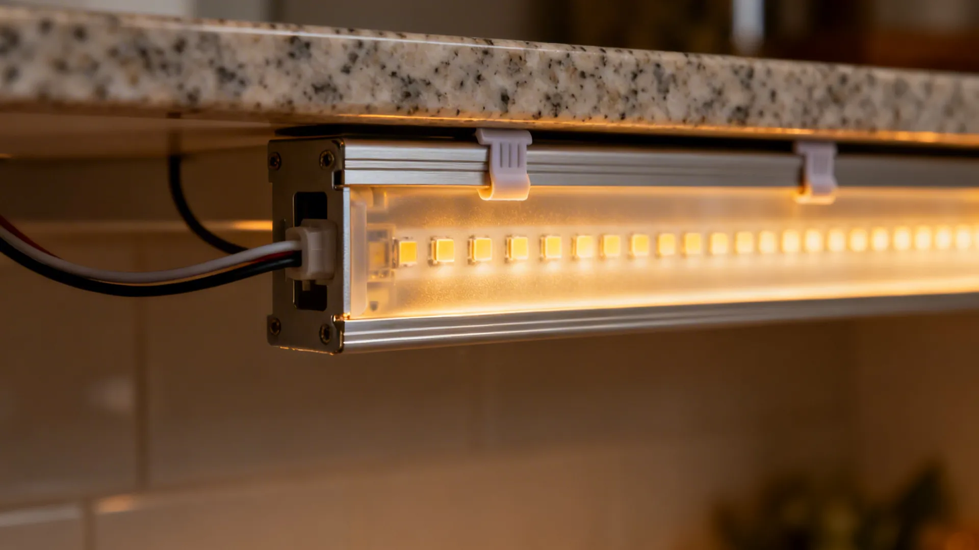 Close-up of a high-density LED strip in a diffuser channel under a cabinet.
