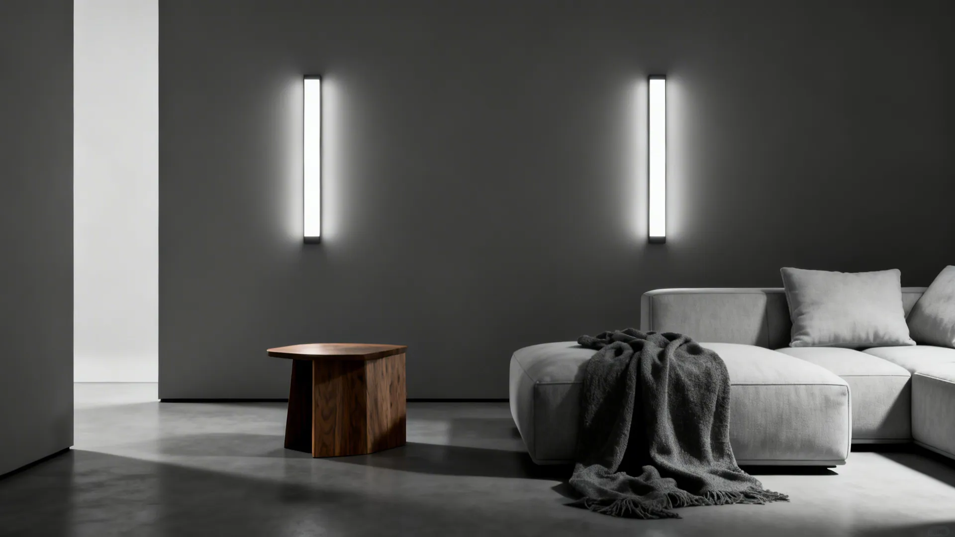 Monochrome minimalist living space lit by slim LED wall panels with warm textile accents