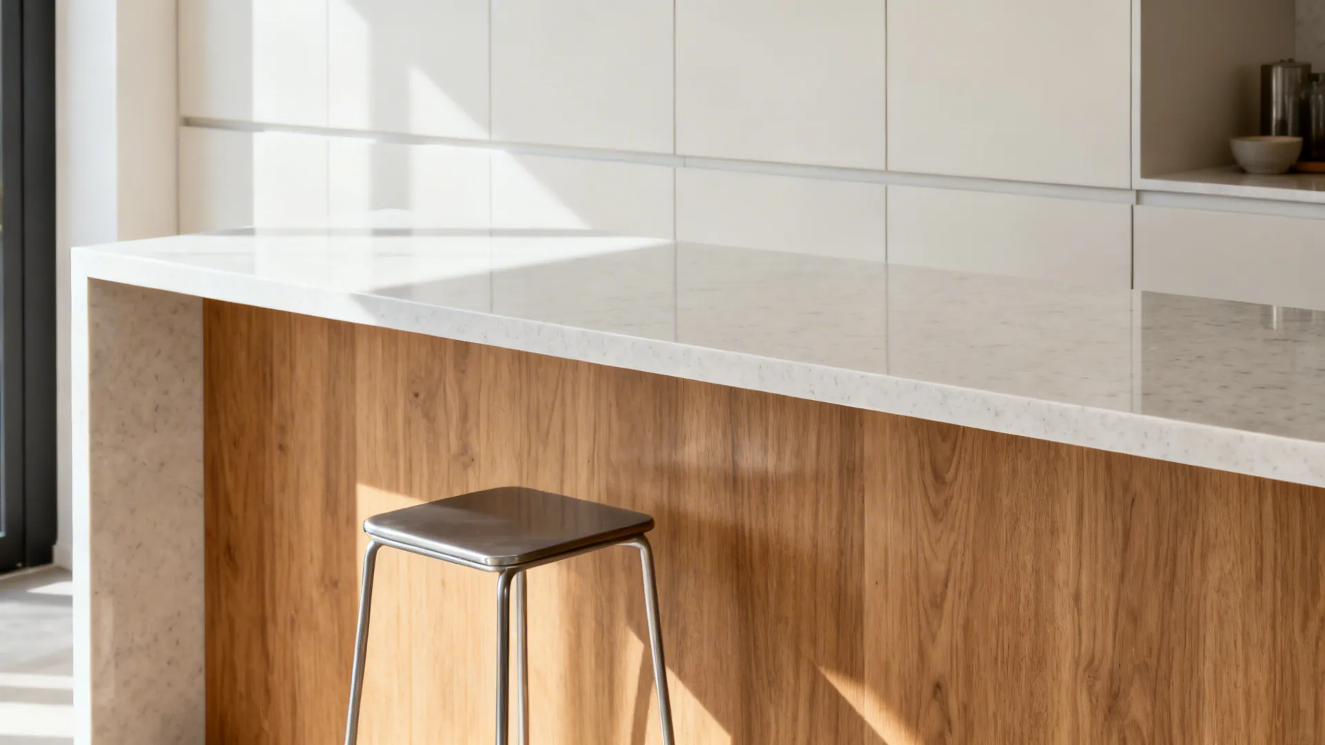 Close-up of a shallow quartz breakfast ledge with slim stool and clean edge detail.