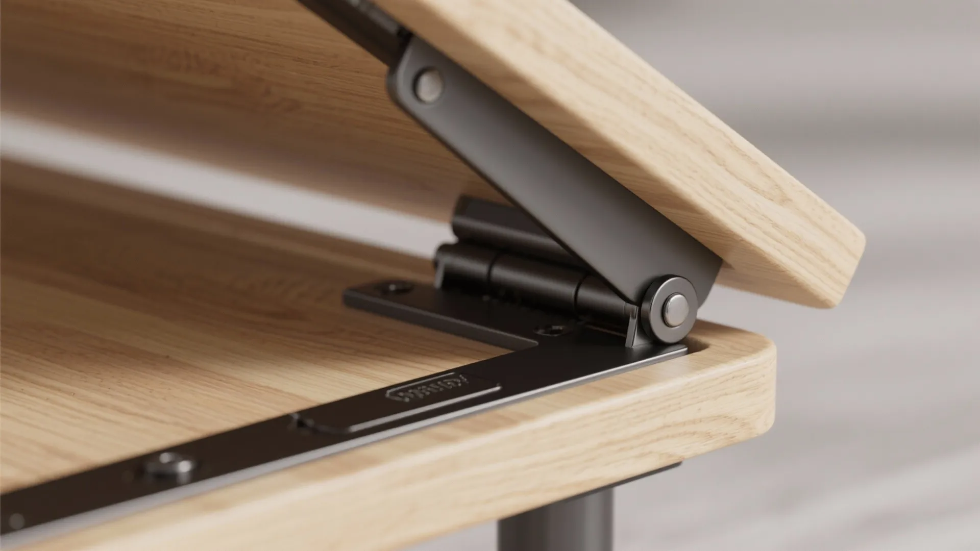 Close up of a black metal hinge mechanism lifting a light wood table top surface panel