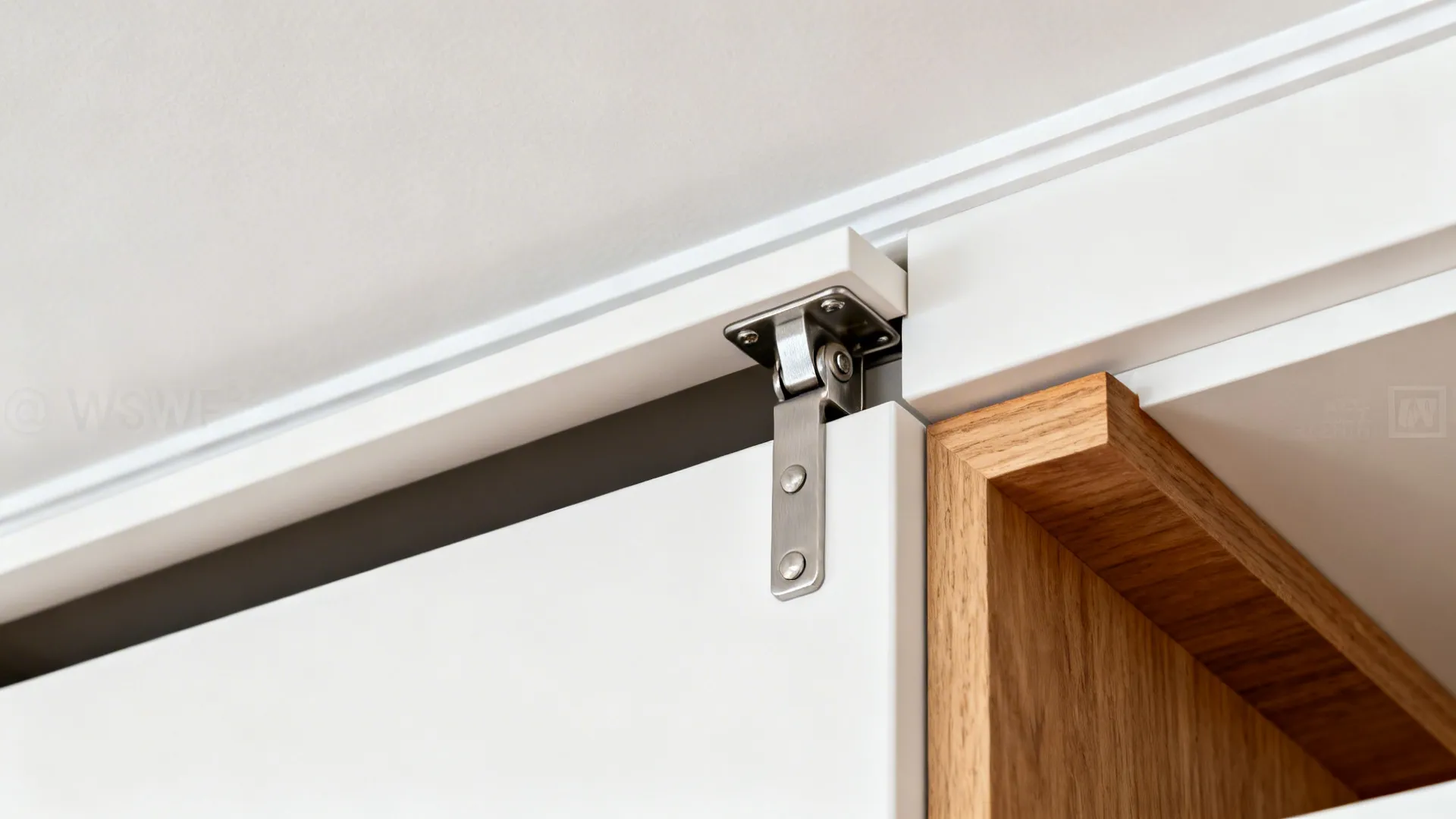 Close-up of a lift-up cabinet mechanism and precise ceiling scribe line.