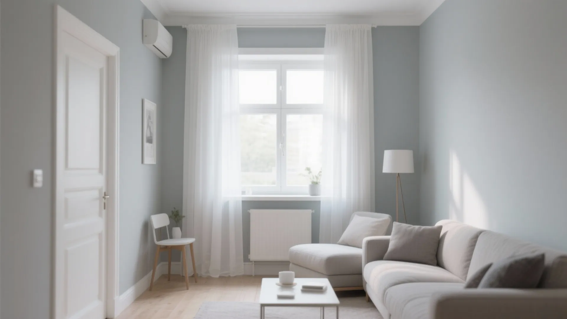 Light grey living room walls with white trim and sheer curtains