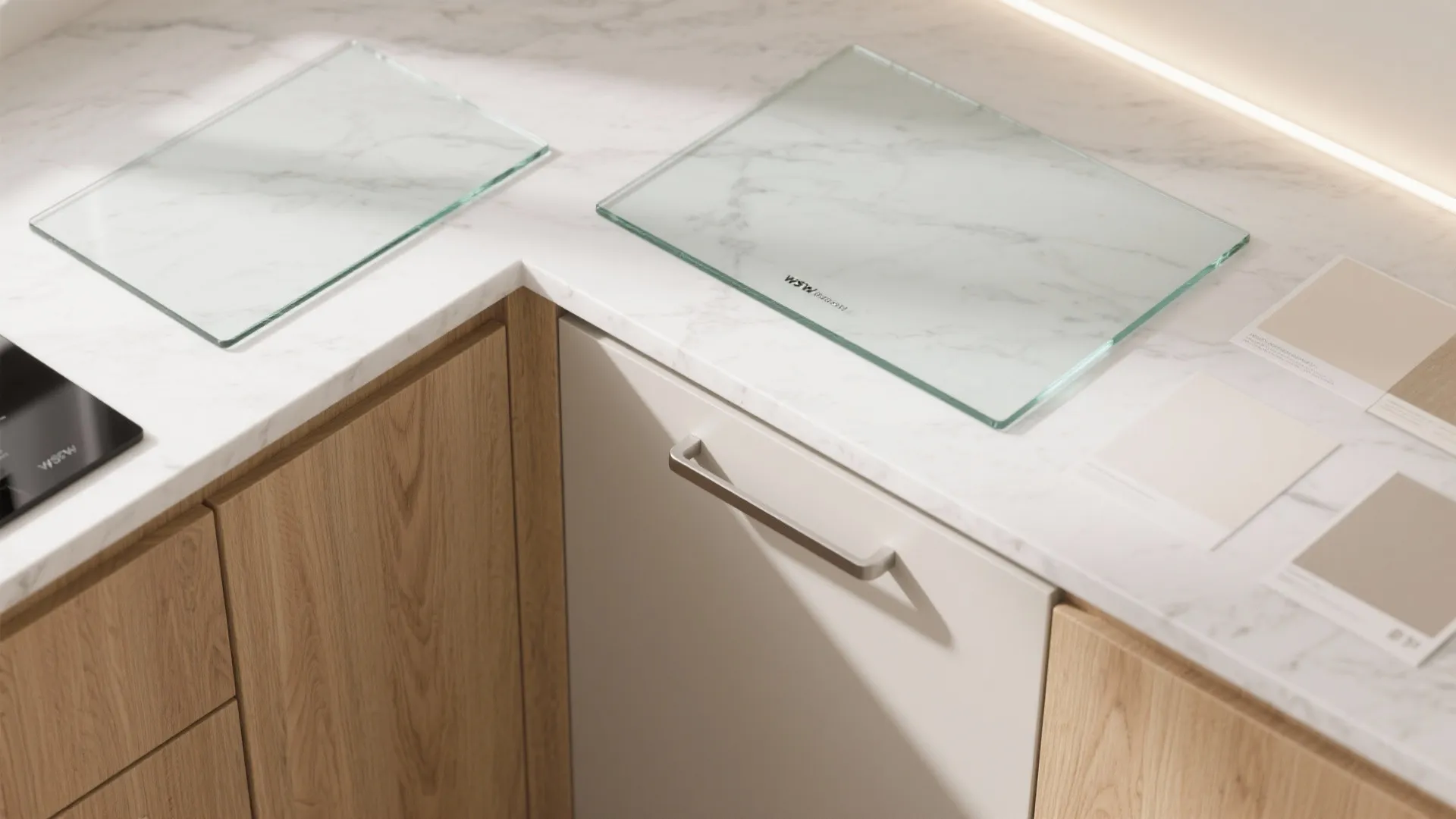 Marble kitchen countertop with glass samples light wood cabinets and several small beige color swatches