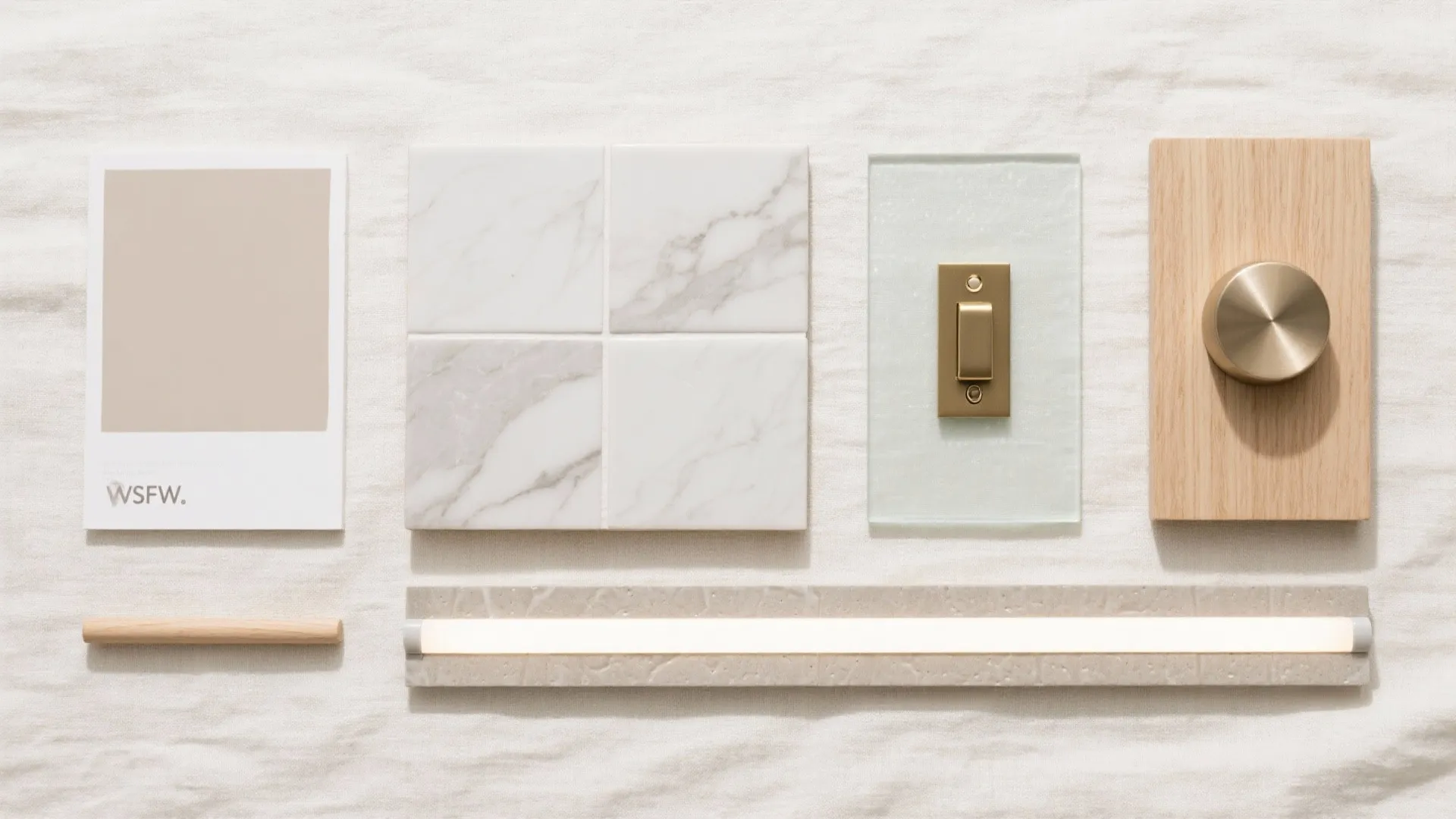 Material mood board with marble tiles wood sample brass switch light fixture and beige color card