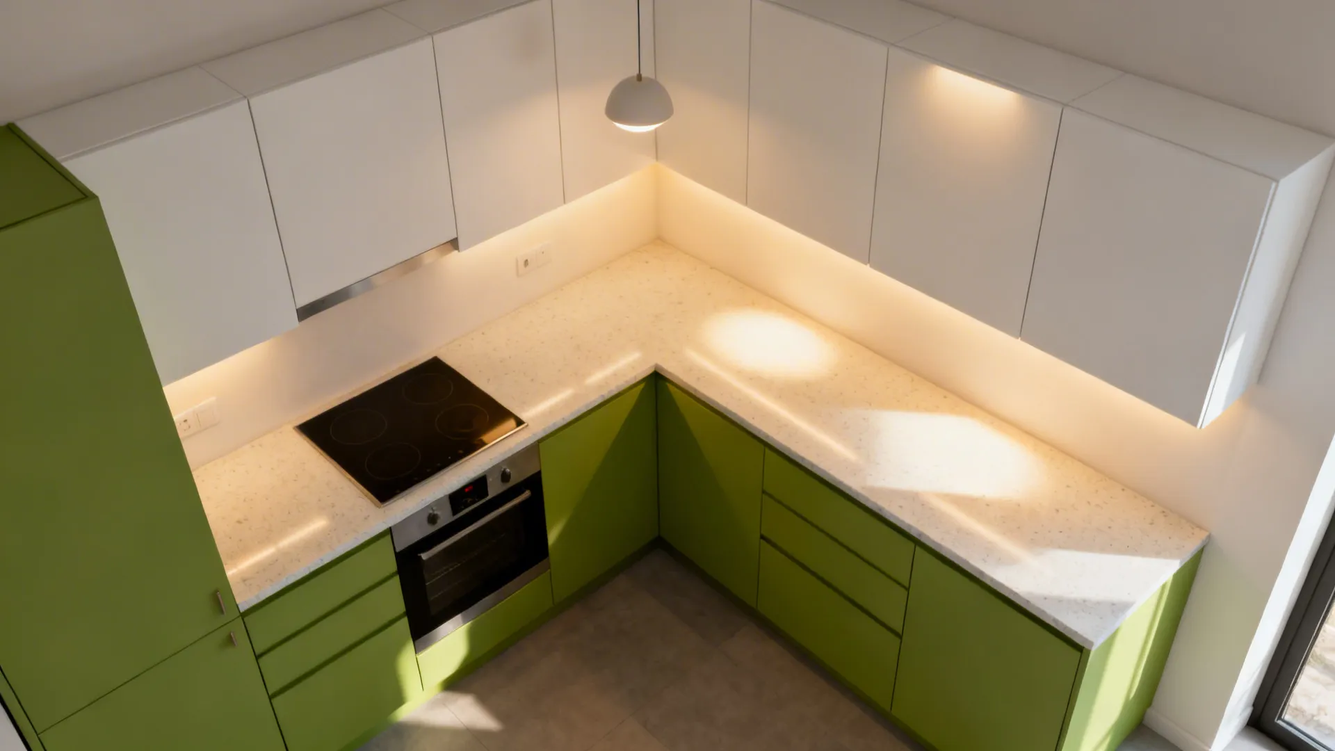 Compact kitchen with layered lighting illuminating apple-green bases and light quartz counters.