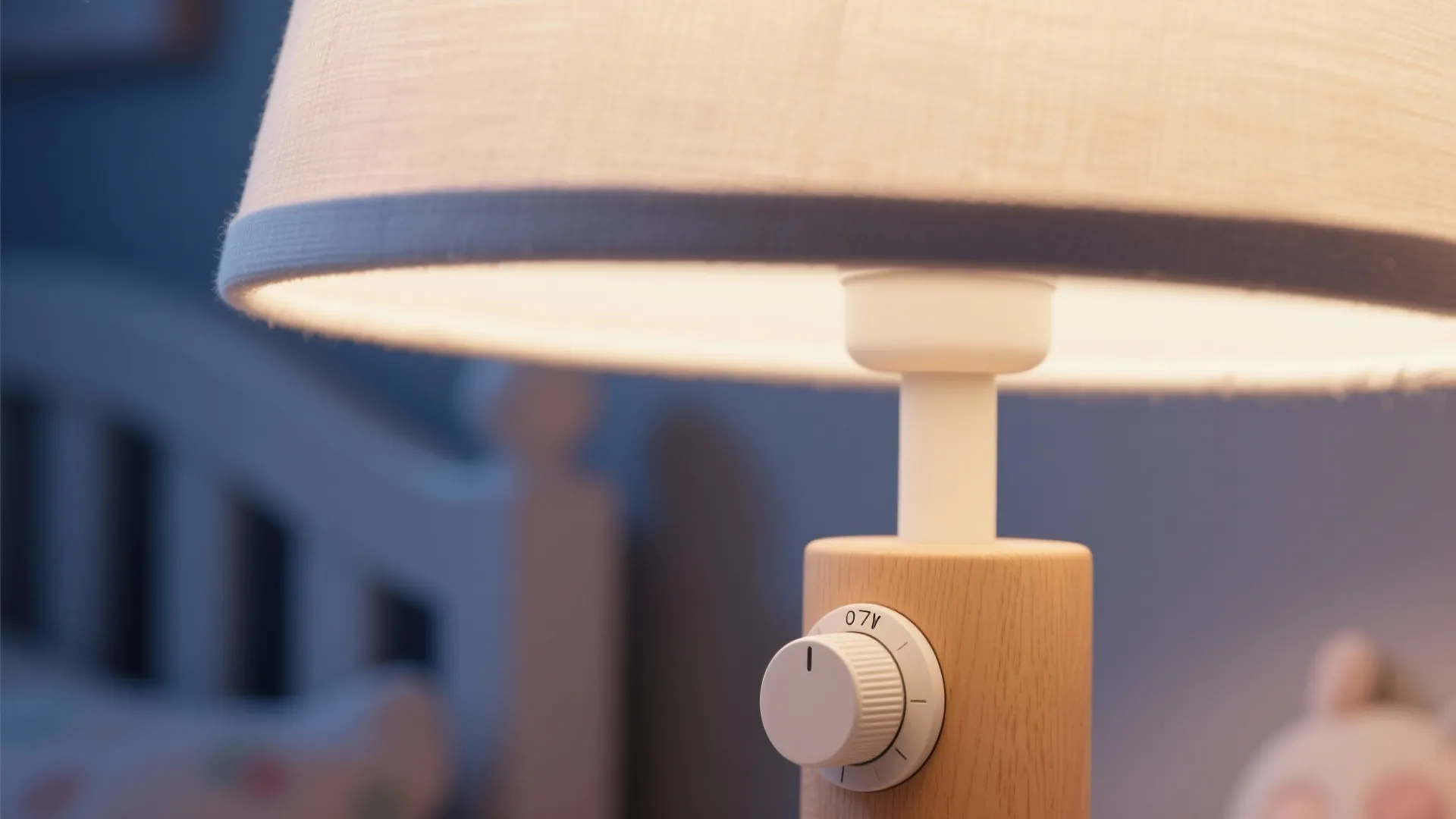 Close up of a wooden table lamp with a white shade and a round dimmer