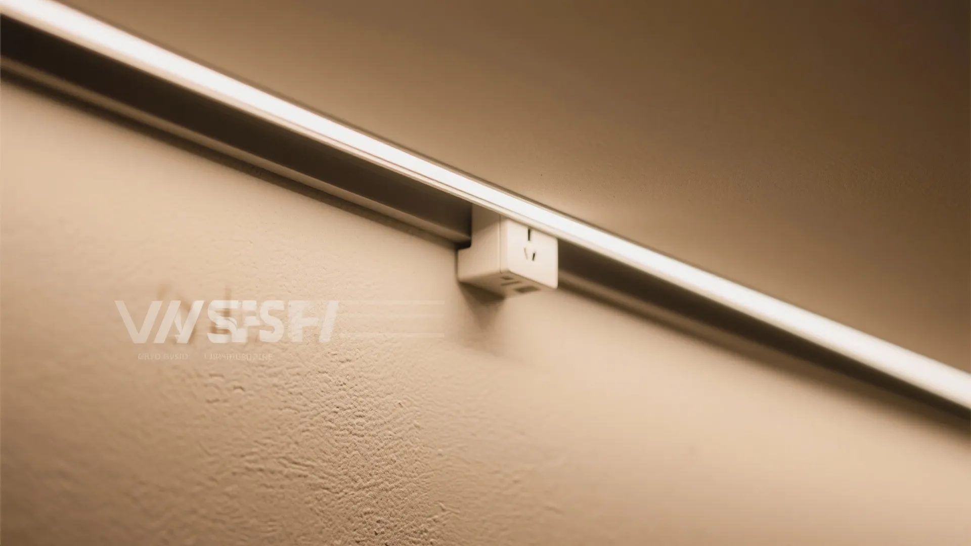 Close up of a modern wall light track with a small white power plug outlet