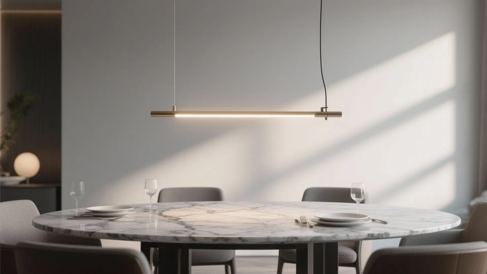 Modern dining room with round marble table plus simple ceiling light and grey chairs setting