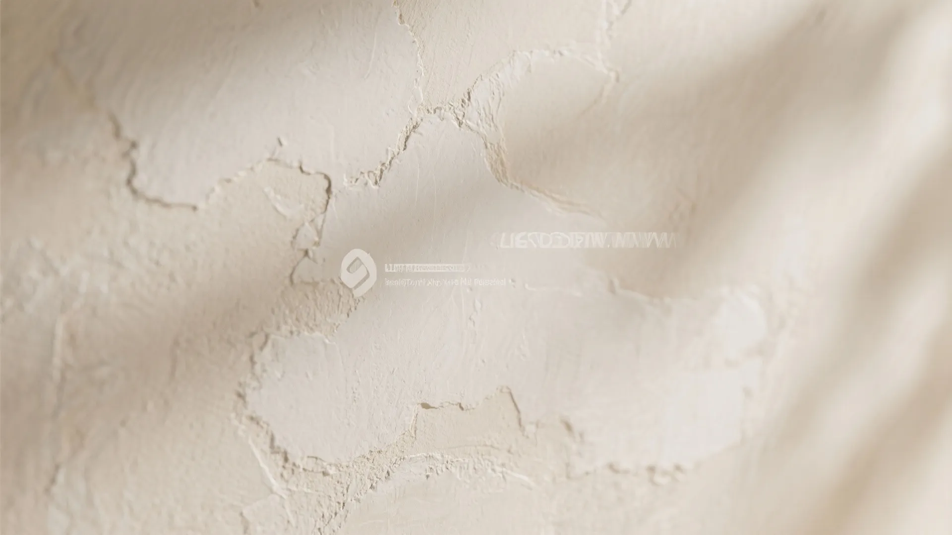 Close up view of textured beige plaster wall finish with soft shadows and sunlight highlights