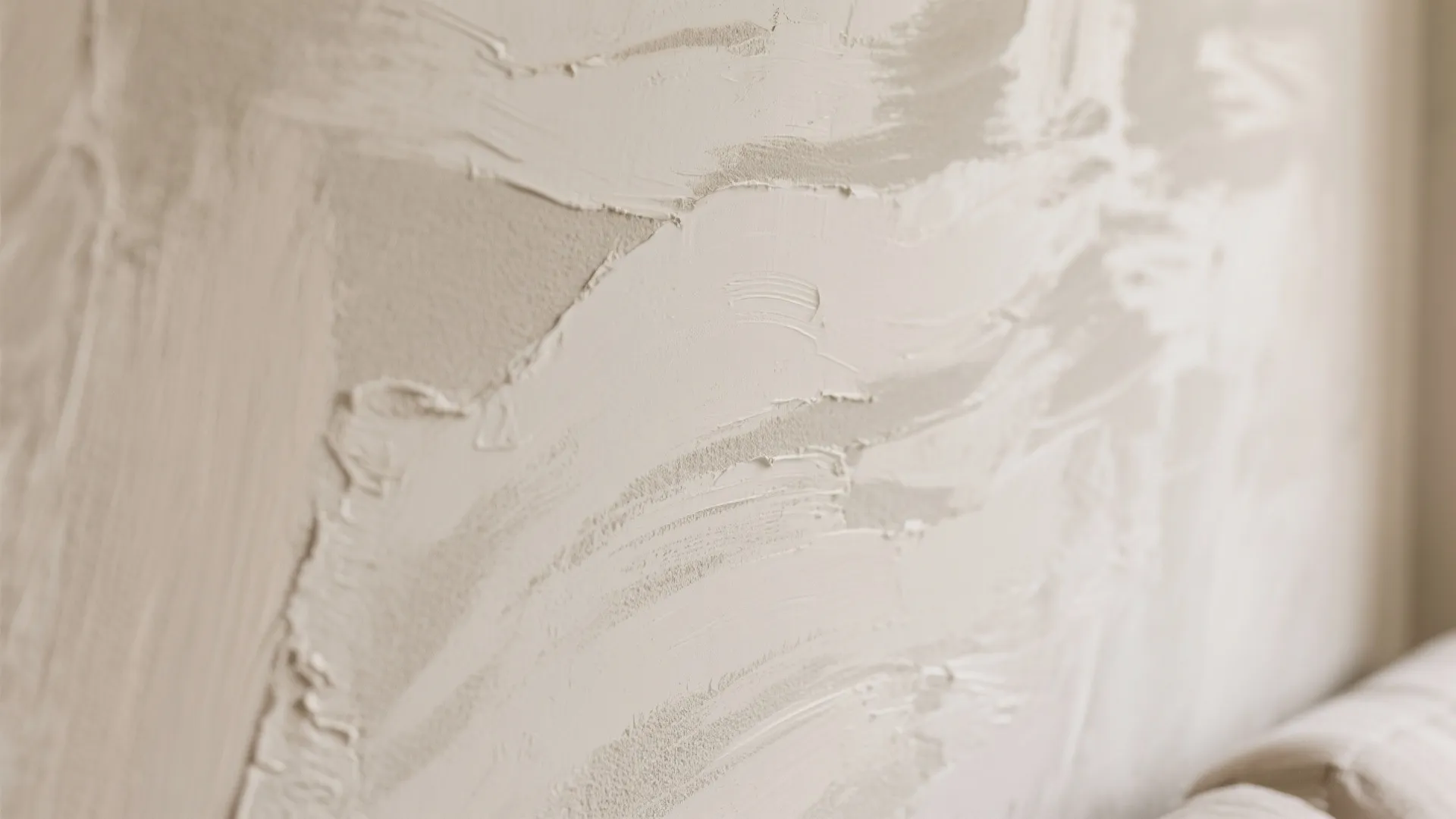 Detailed view of light beige wall texture with soft plaster marks for a modern design