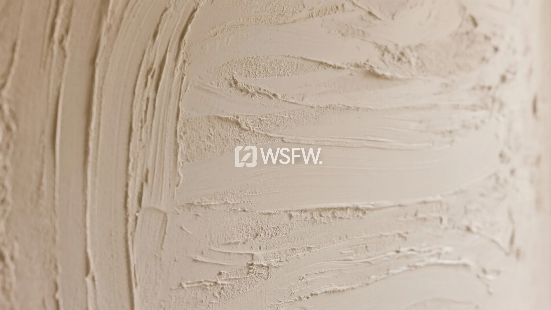 Macro detail of limewash plaster on a big wall design, showing subtle brush strokes under grazing light.