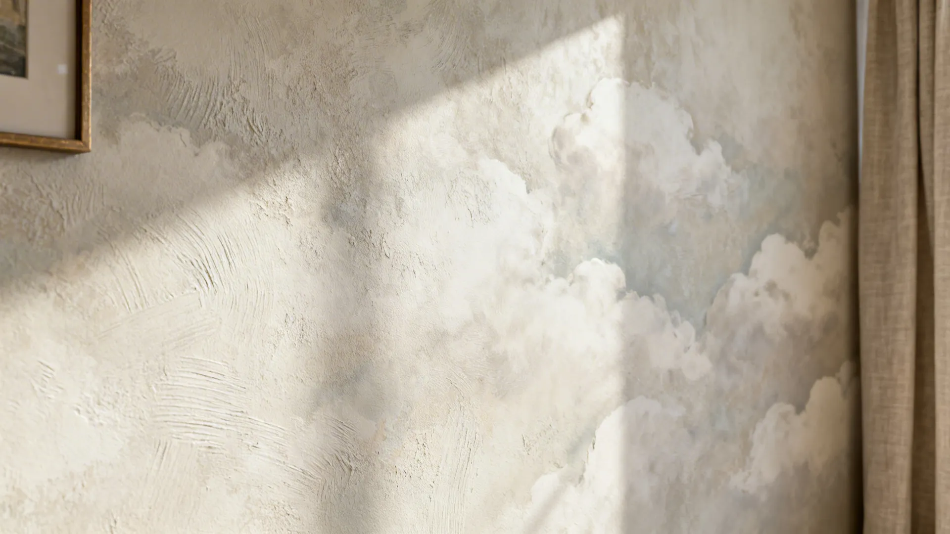 Macro view of a limewash wall with soft, cloud-like texture and subtle tonal movement in a living room.