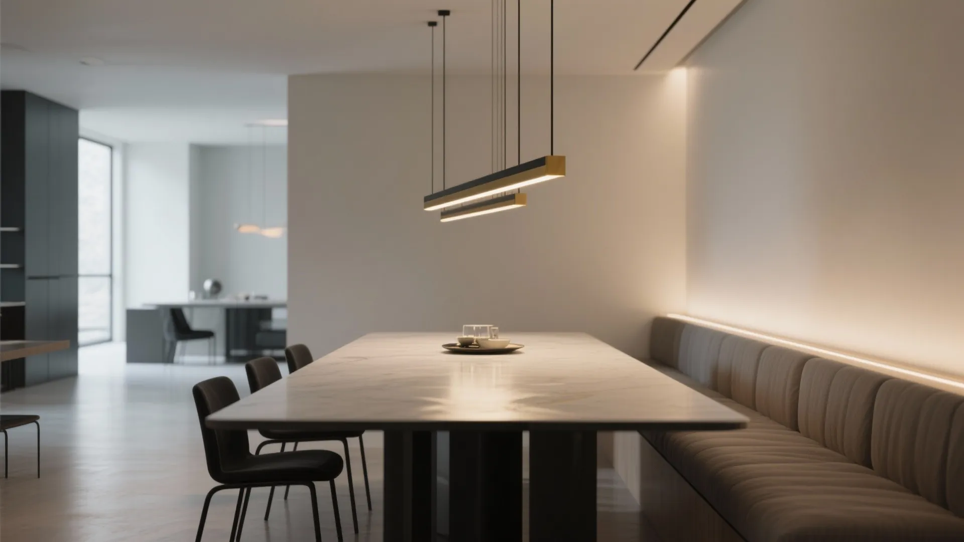 Minimalist dining room with long marble table and sleek black linear light fixtures hanging above