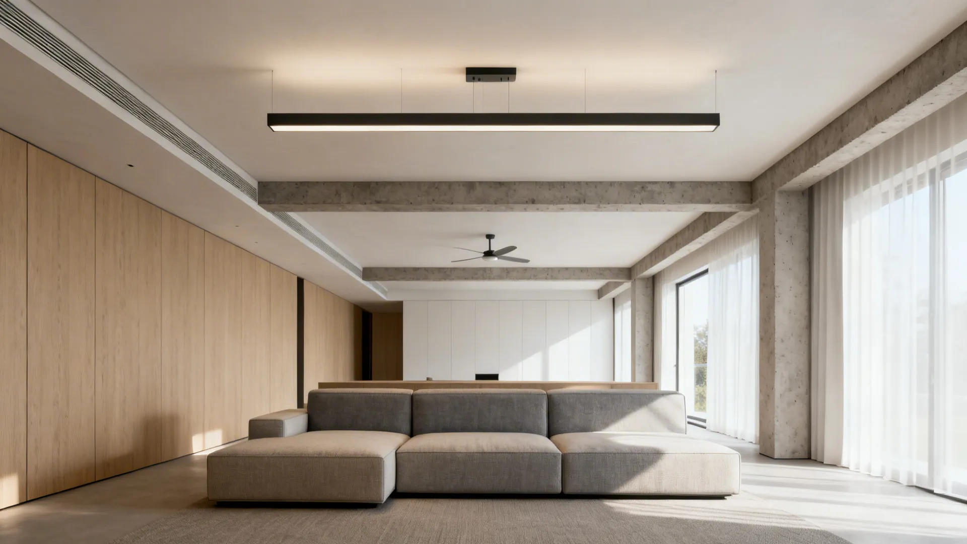 Long living room with a minimalist linear chandelier and concealed downdraft fan over a sectional.