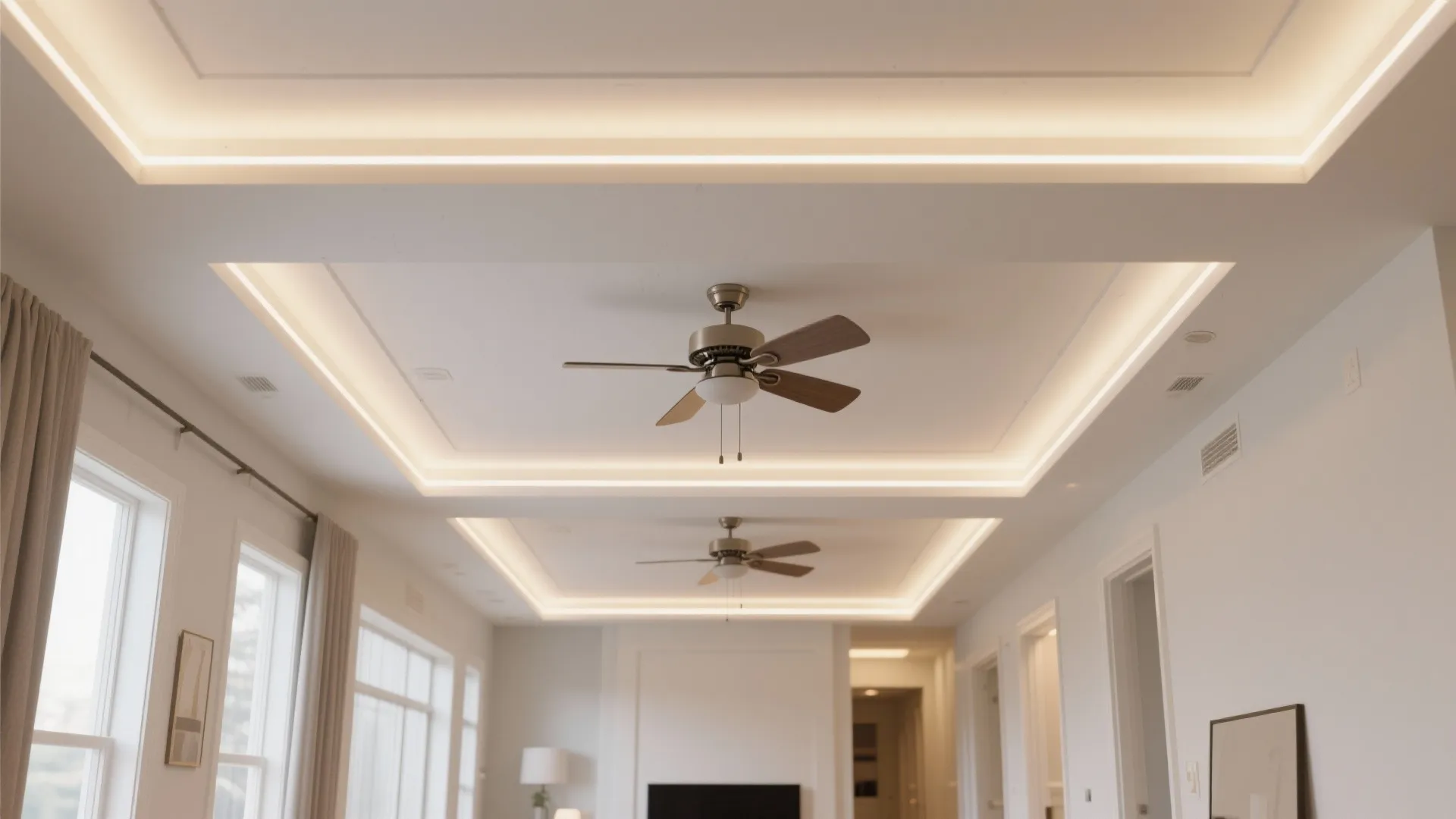 Modern ceiling design with two wooden fans, recessed lighting, white walls, and bright side windows