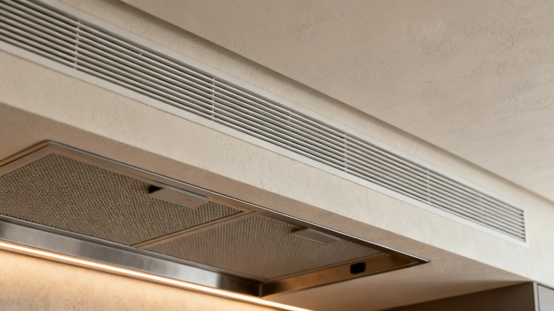 Macro of flush linear extract grille integrated into moisture-resistant plaster ceiling.