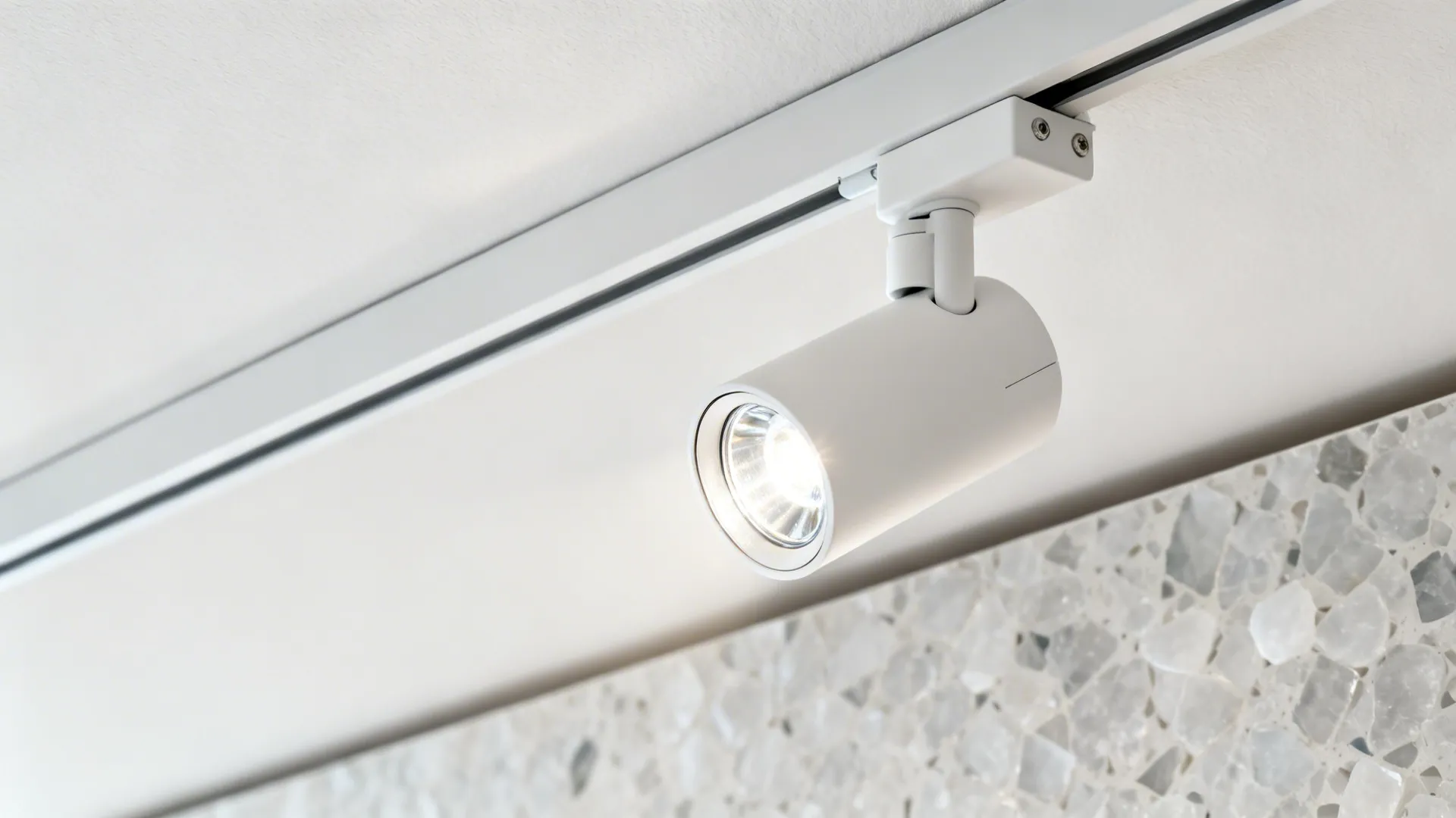 Macro view of a matte white linear track head with high-CRI LED and tilt mechanism.