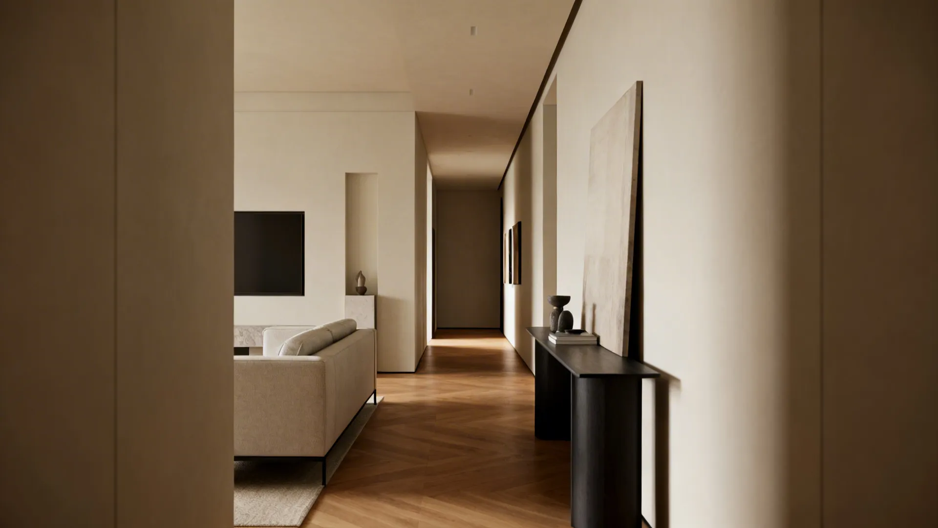 Long hallway with wood floor leading to living room with grey sofa and black cabinet
