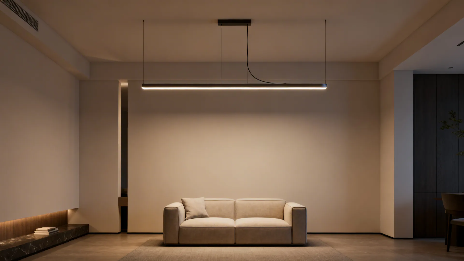 Small living room featuring a suspended linear LED fixture acting as a sculptural centerpiece.