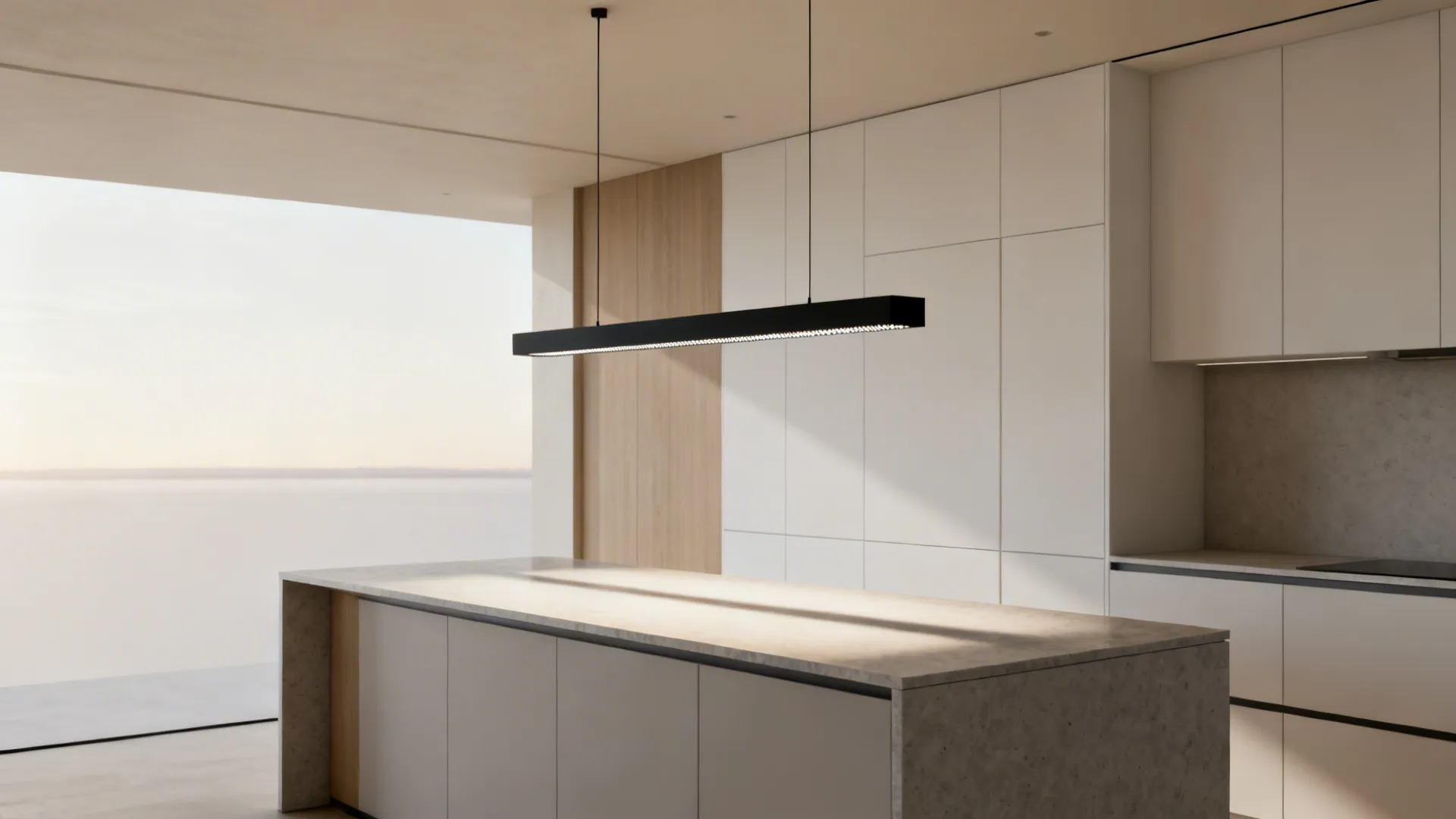 Modern kitchen island with black linear ceiling light white cabinets and stone countertop in bright room