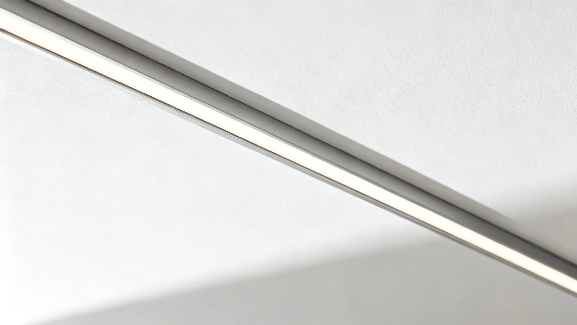 Close-up of a recessed ceiling linear light with seamless diffuser and minimal trim.