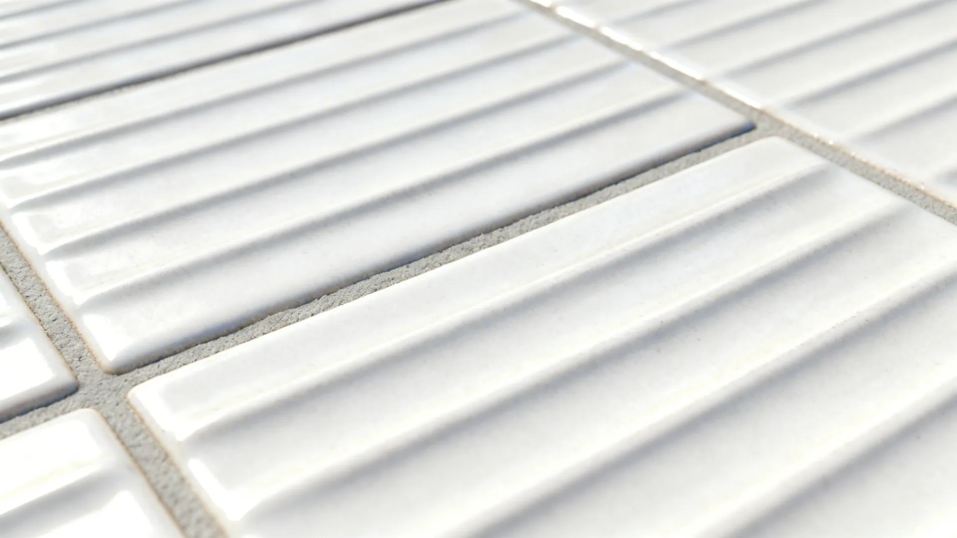 Macro of shallow linear rib texture on white ceramic floor tile.