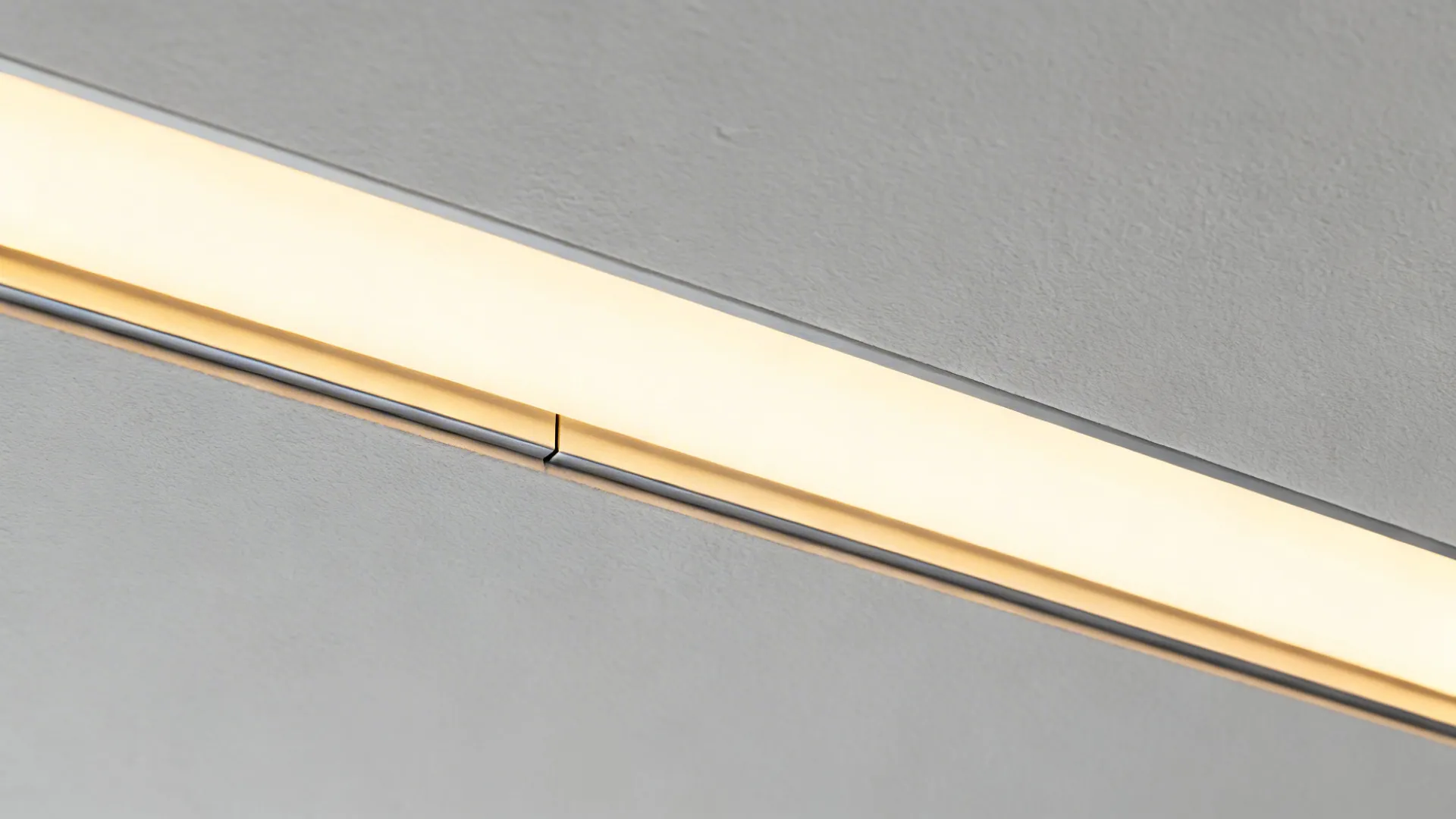 Close-up of a POP linear light slot with opal diffuser and clean plaster edges.
