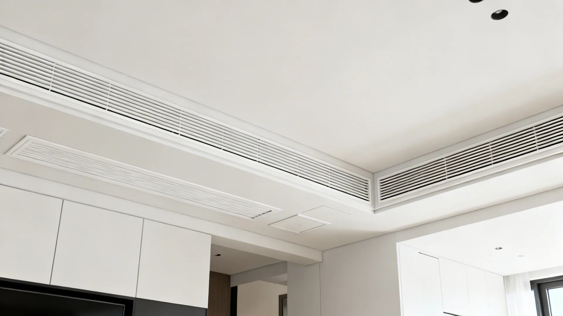 Minimalist ceiling with continuous linear slot diffusers and concealed access panels.