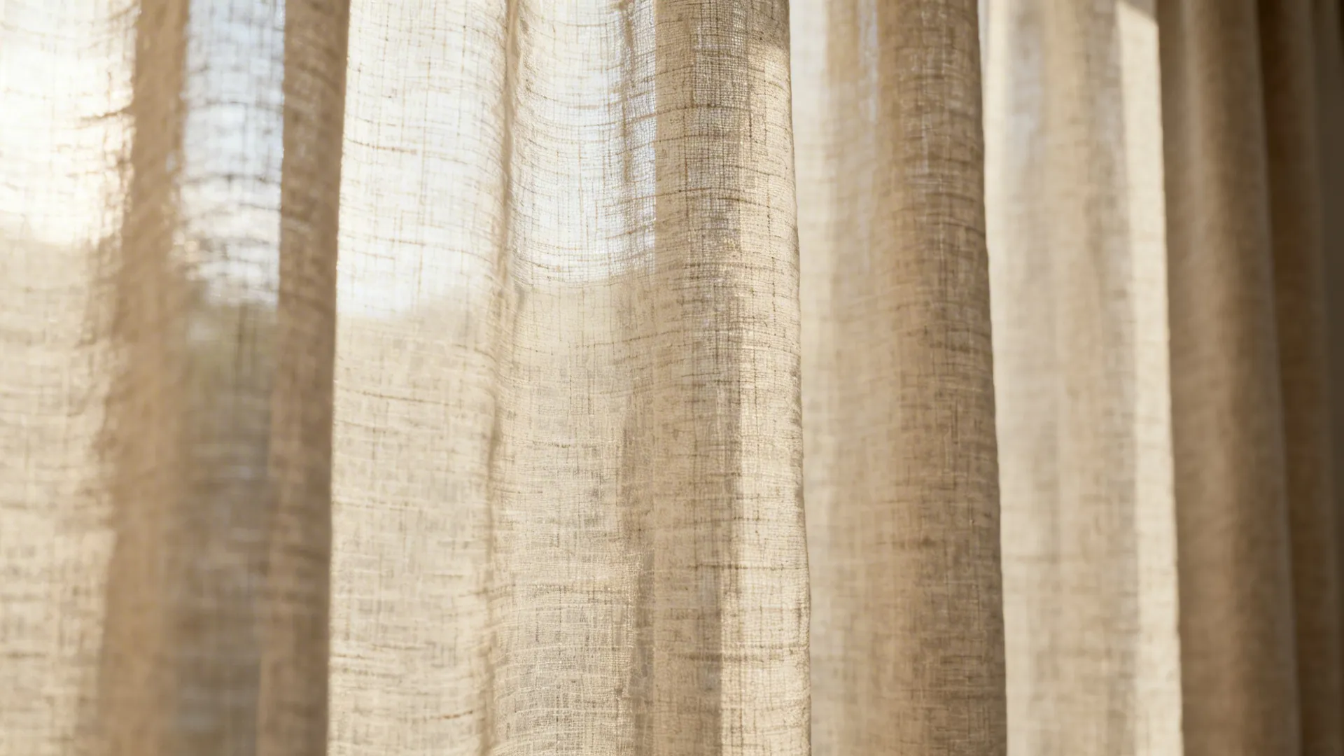 Close-up of neutral linen-blend curtain showing soft weave and light diffusion.