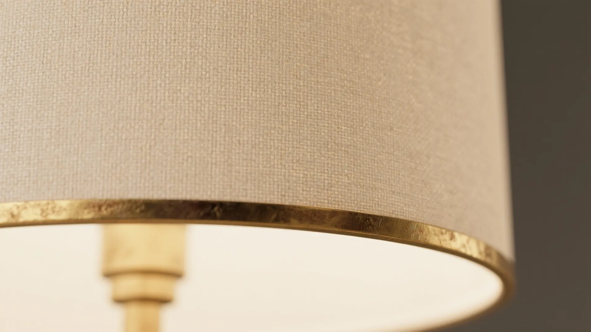Macro of linen drum shade and warm brass trim with soft diffused glow.
