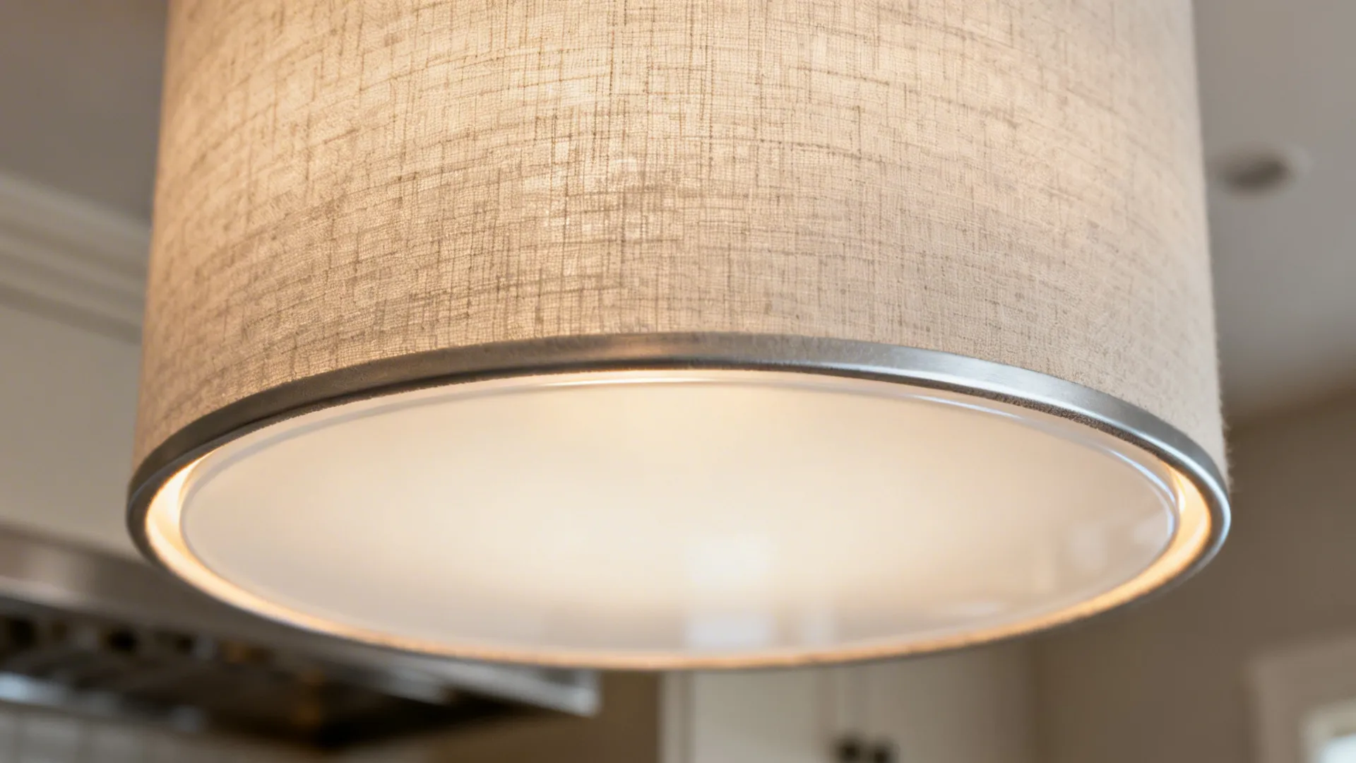 Close-up of a linen drum flush mount with sealed frosted diffuser and matte trim.