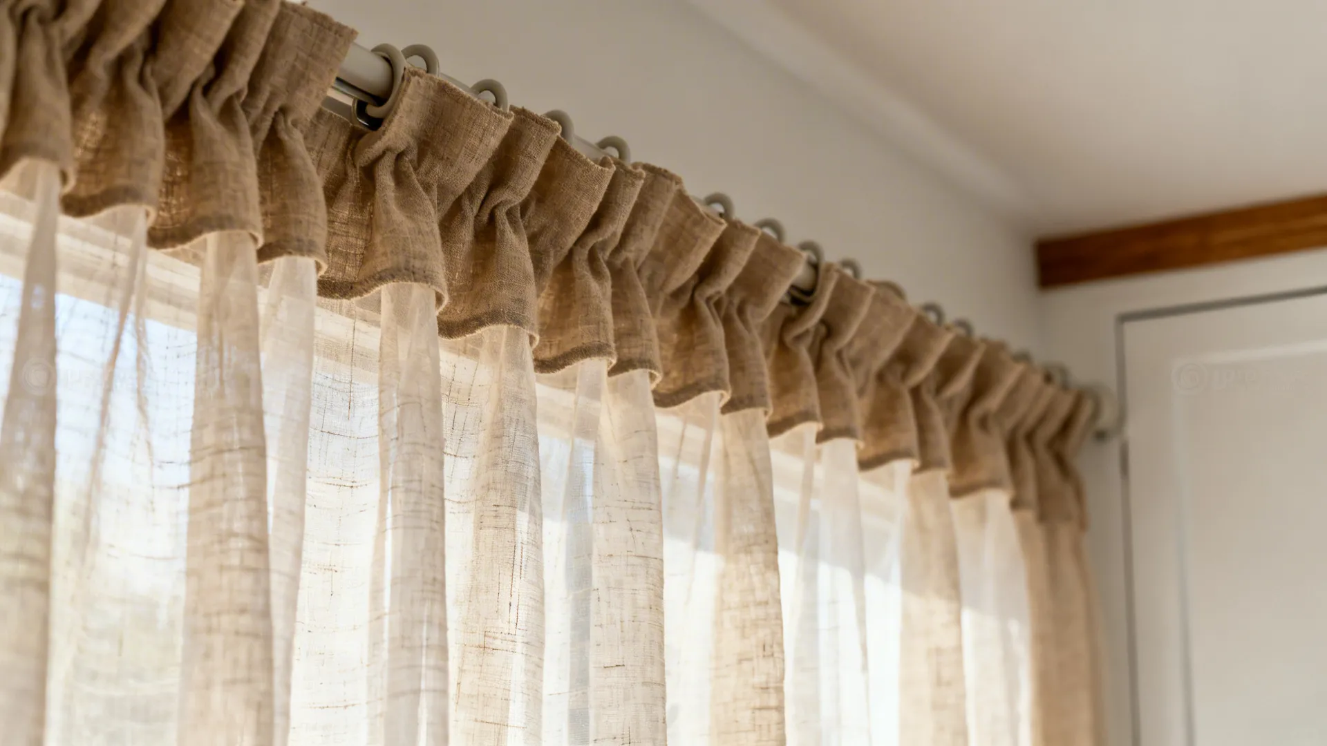 Macro of sheer linen layers on a ripplefold track showing texture and weighted hem.