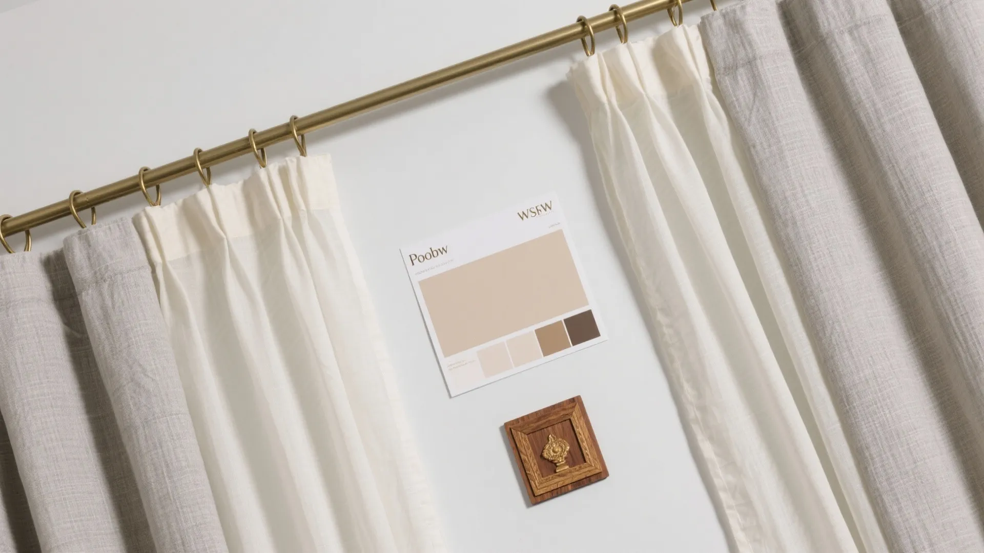 Top-down flat lay of linen sheer, cotton blackout, brass clips, and slim double track in neutral tones.