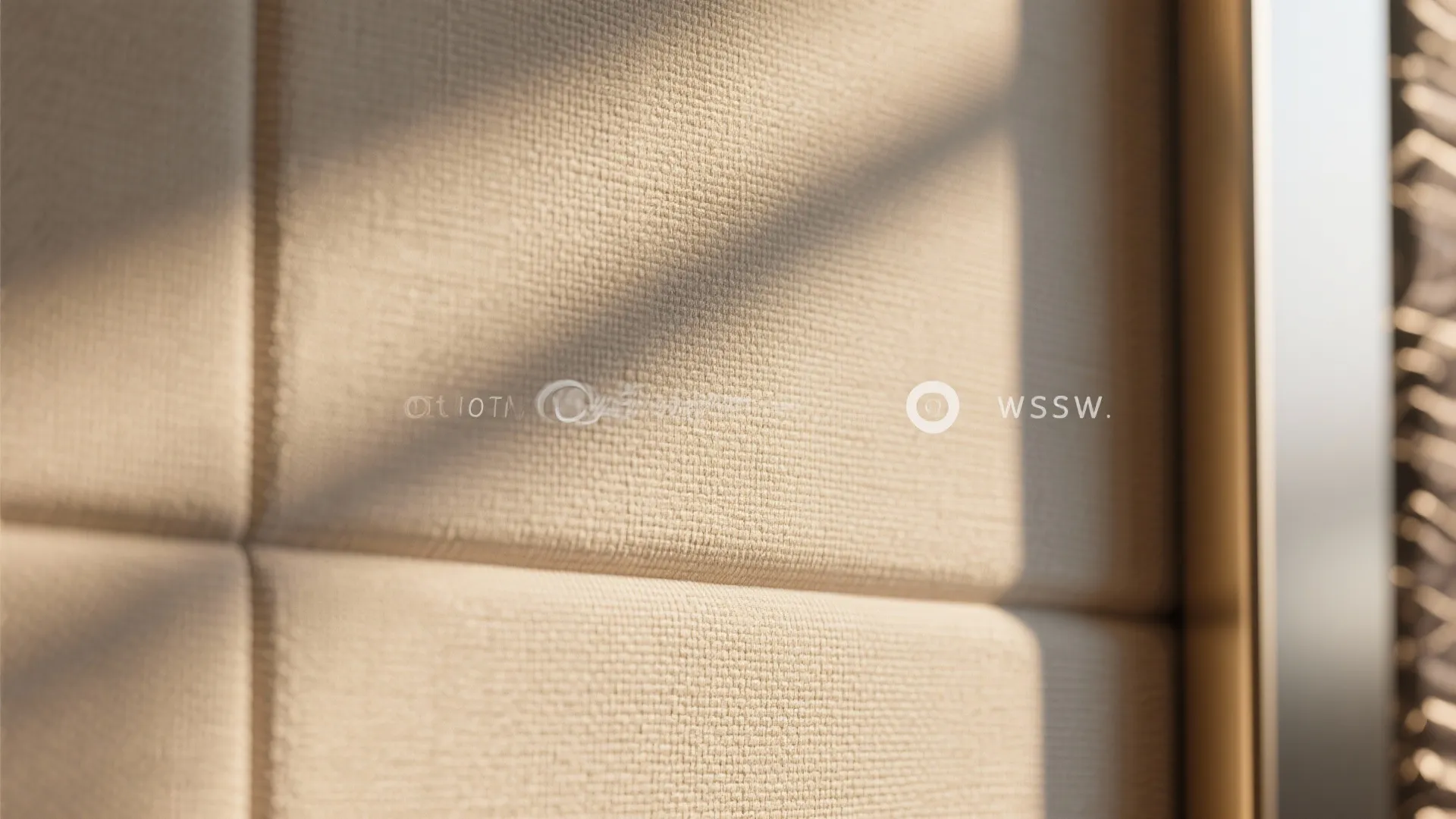 Close-up of neutral faux-linen textured wallpaper with subtle weave pattern