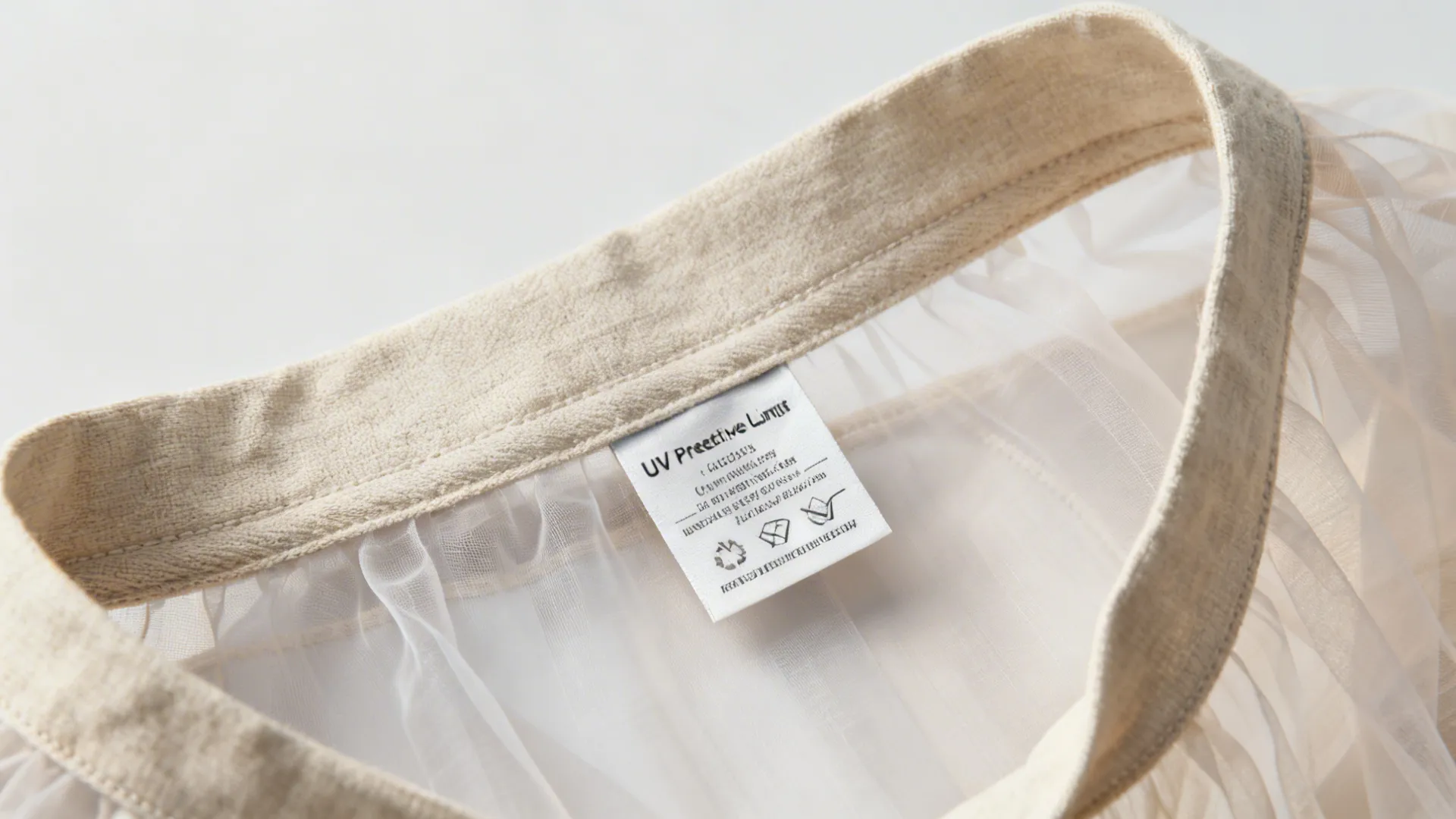 Close-up of curtain lining samples and care label showing fabric care and UV-protective lining.