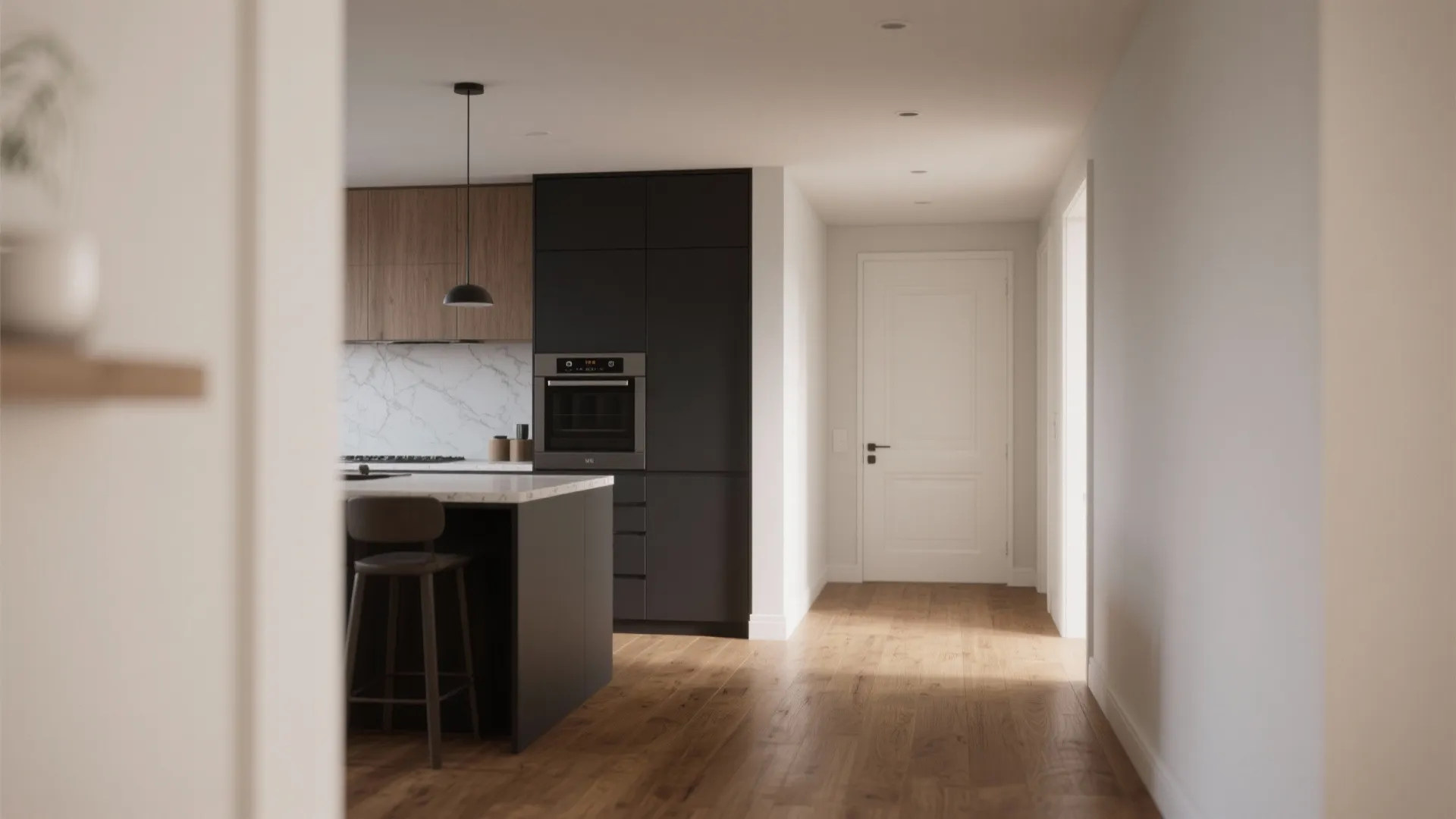 Modern kitchen with dark cabinets wood flooring and a white door leading to a hallway