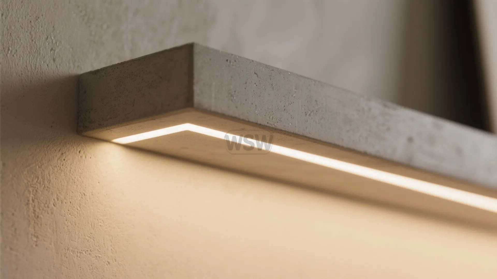 Close up of gray wall shelf with a hidden light fixture providing warm downward soft lighting