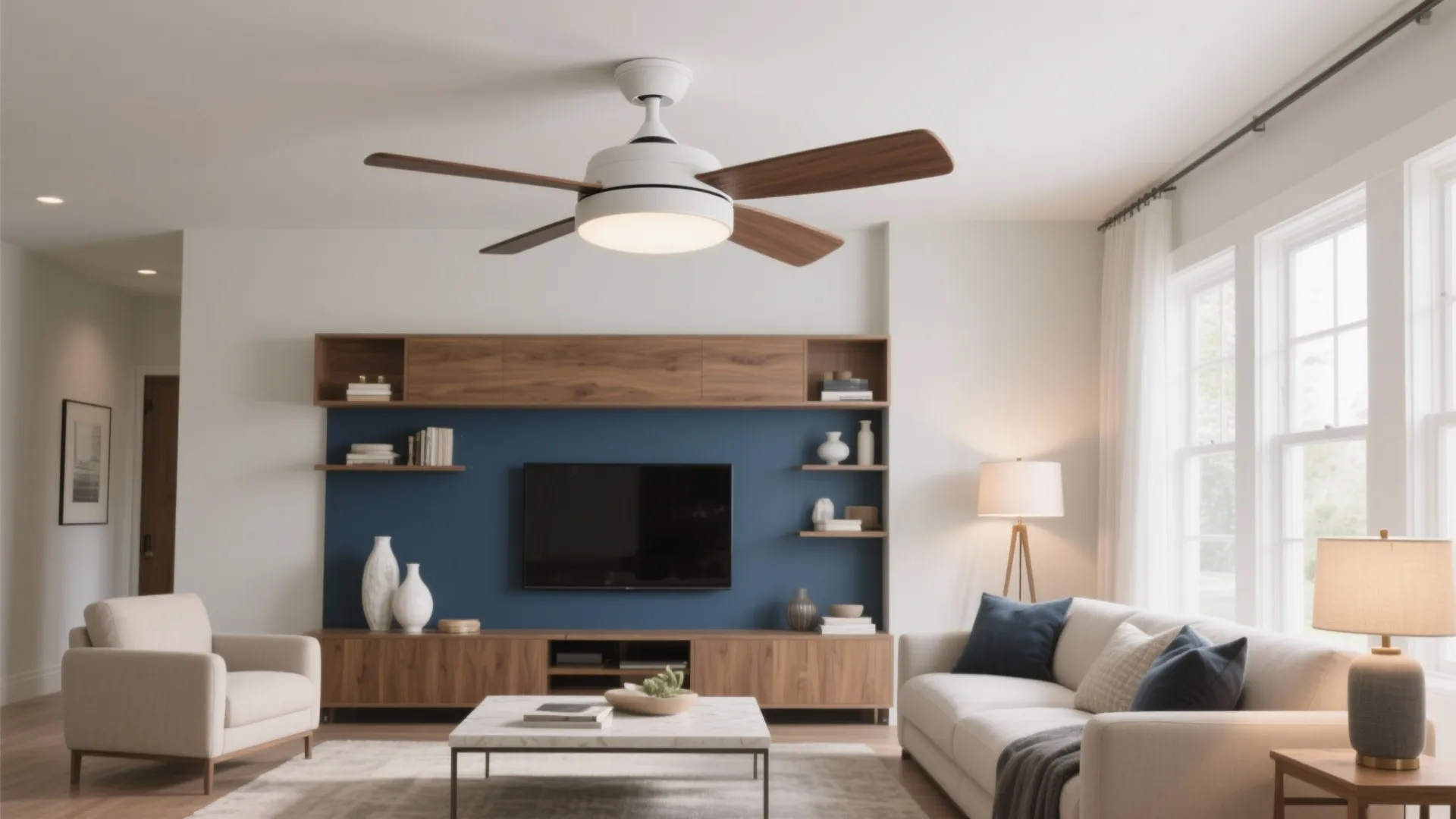 Modern living room with ceiling fan light wood cabinet blue wall white sofa and coffee table