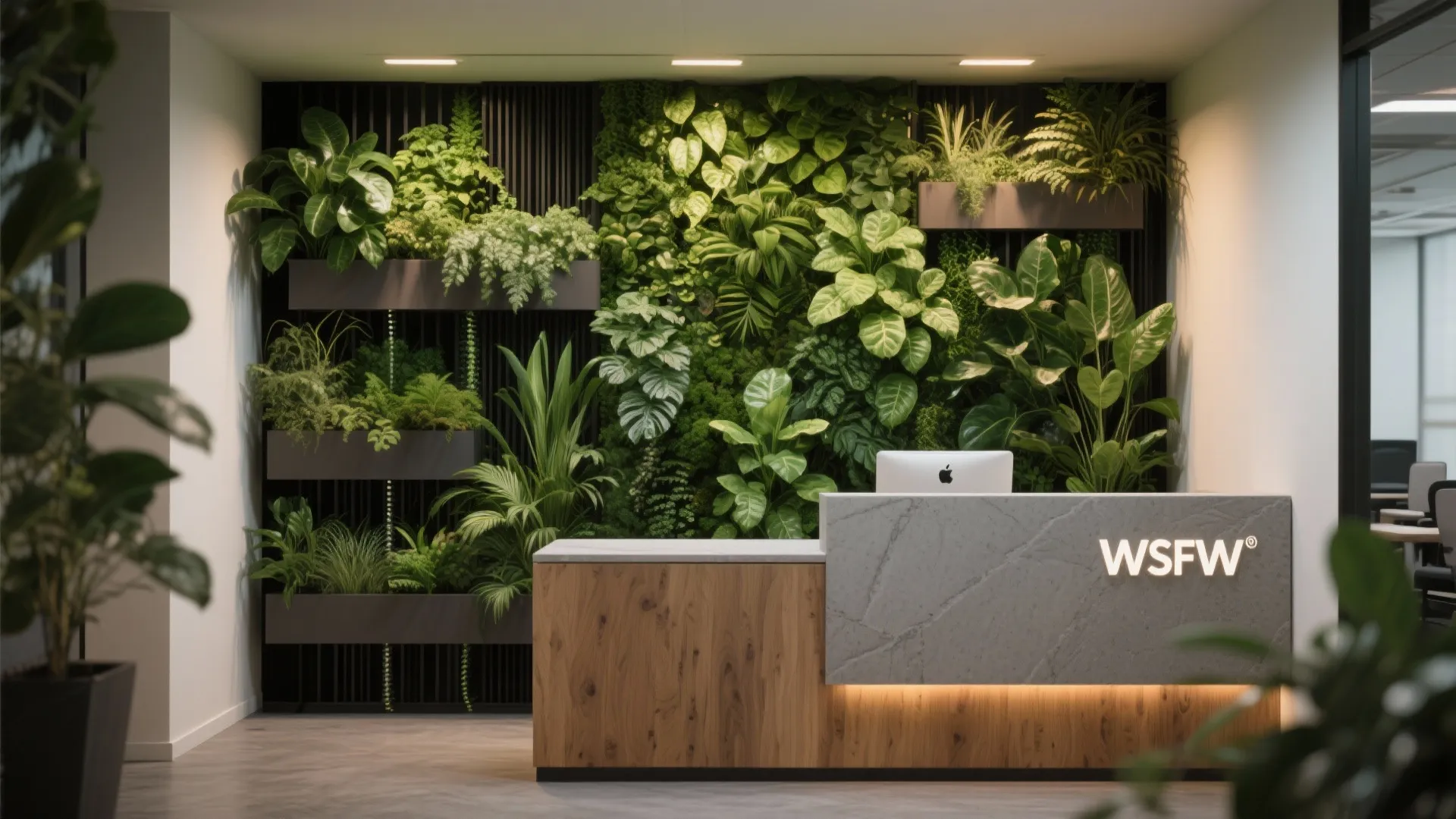 Reception area with a slim living wall of vertical greenery doubling as acoustic and visual backdrop.