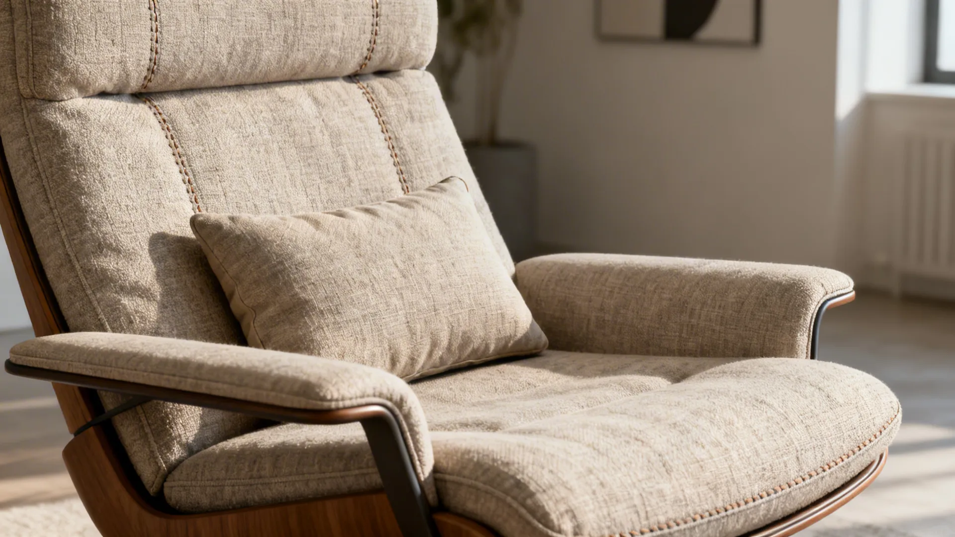 Close-up of a low-profile swivel recliner with slim arms and a lumbar cushion in neutral fabric