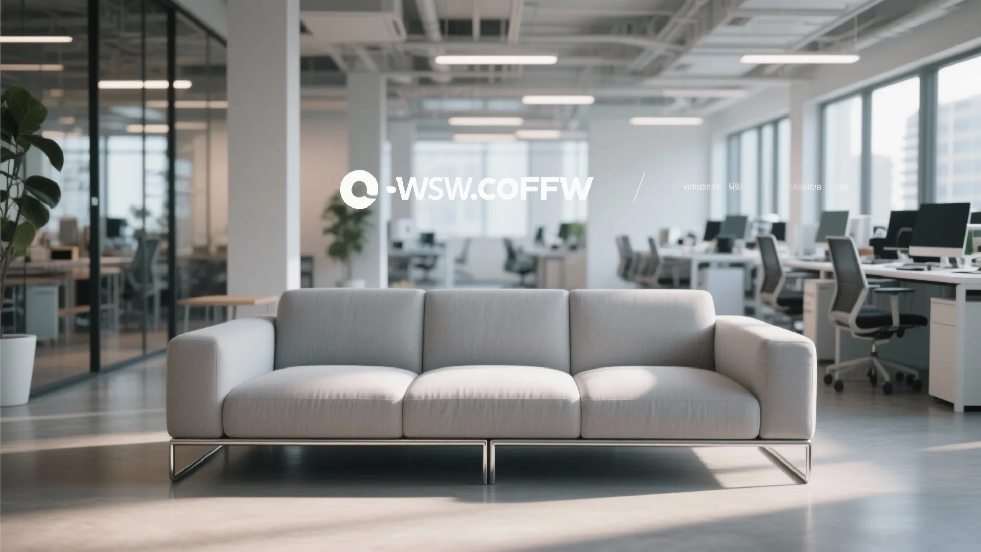 Modern grey three-seater sofa with metal legs placed in a bright open plan office space