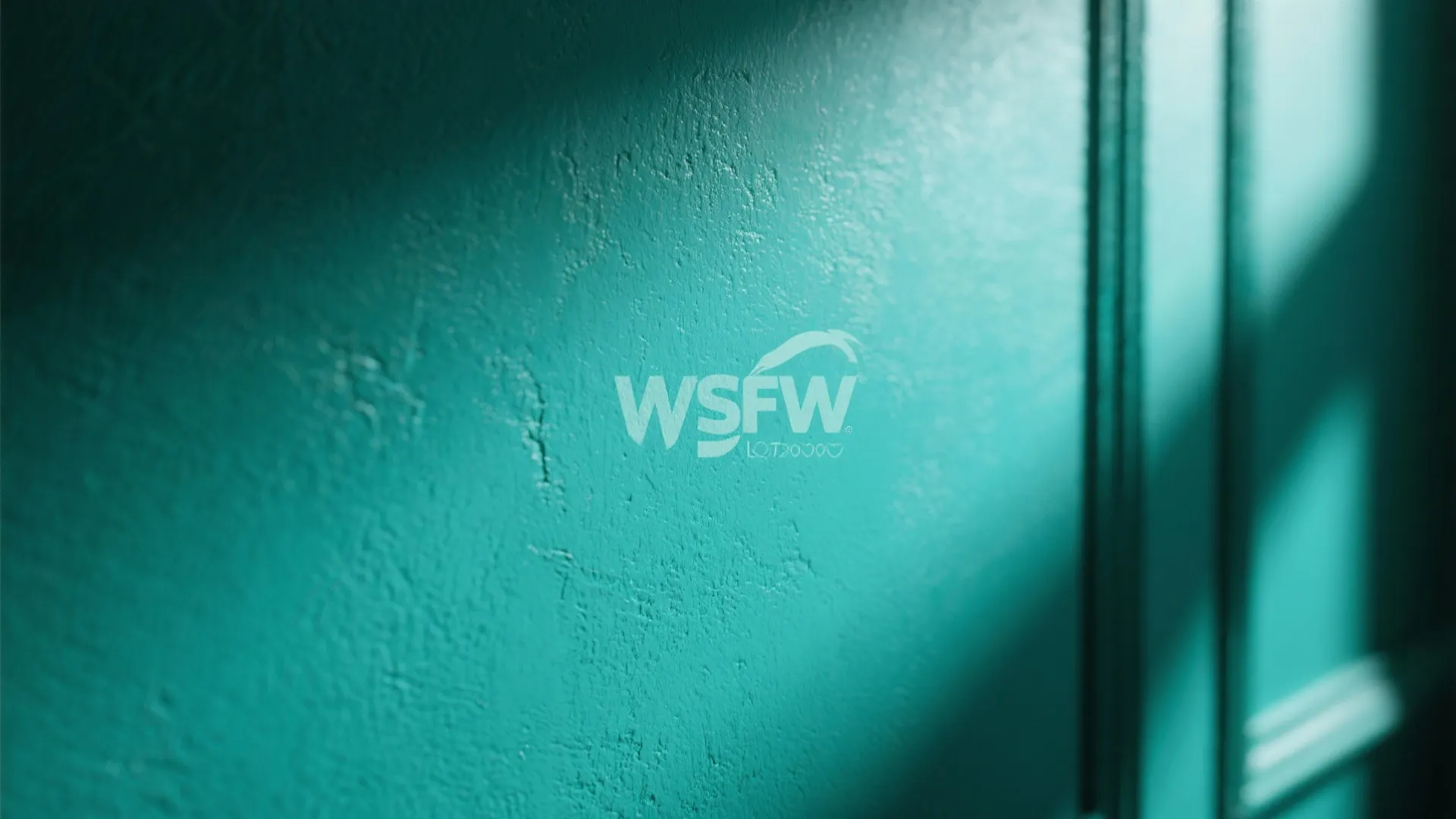 Close up view of teal wall paint texture with sunlight and shadows on the surface