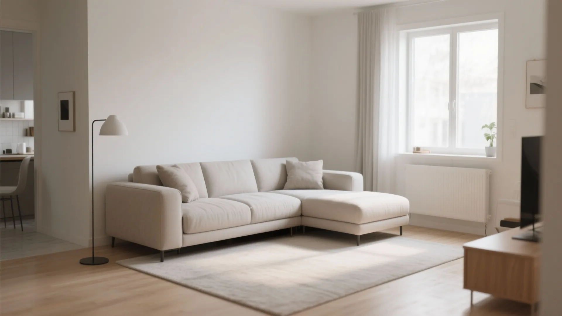 Minimalist cream sofa in a bright living room with wooden floors and a floor lamp