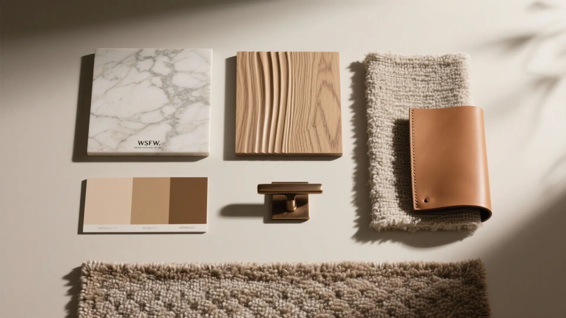 Material mood board with marble tile wood panel leather sample rug and earthy color palette