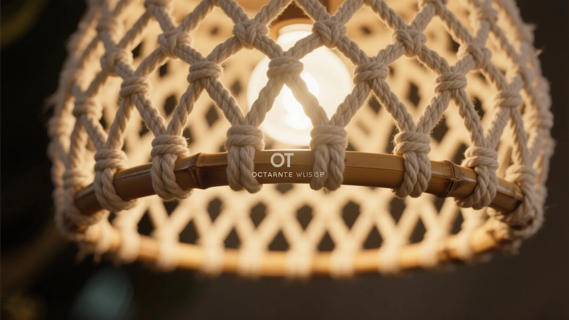 Close up of a woven rope and bamboo ceiling light with a glowing light bulb