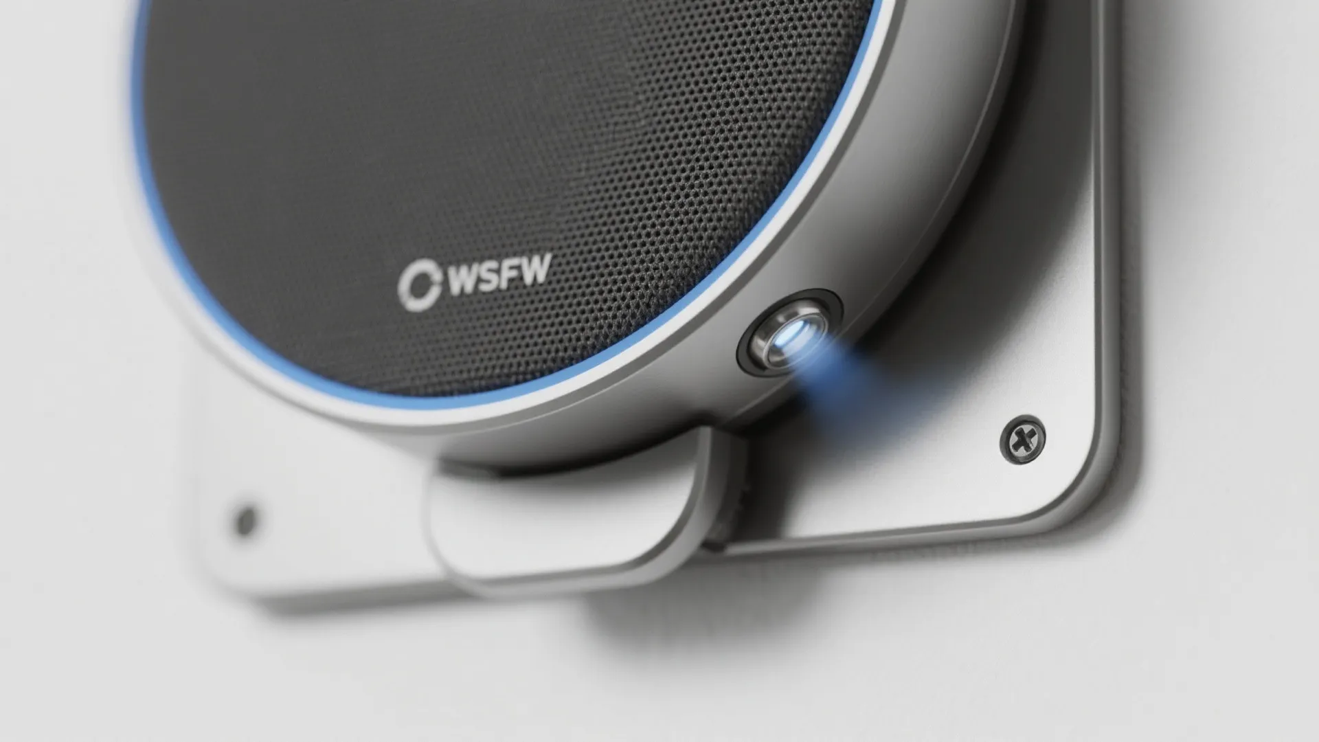 Close-up of a slim magnetic dock showing the metal plate on a compact smart speaker and the matching wall plate.